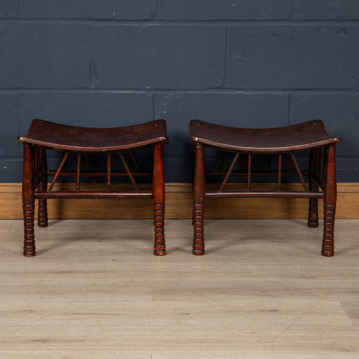A lovely pair of Thebes stools attributable to Liberty and Company in London. The inspiration for the Thebes stool was the collection of Egyptian domestic antique furniture discovered at Thebes in Egypt which had been acquired by the British Museum