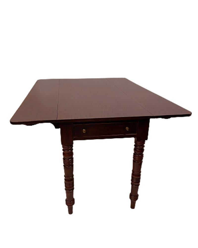 20th Century English Pembroke dining or side table.

An English Pembroke table in mahogany color with folding tops supported on 3 ellenbows each side. On the head of the table is on each side a drawer. The table can be used as a dinner table, but