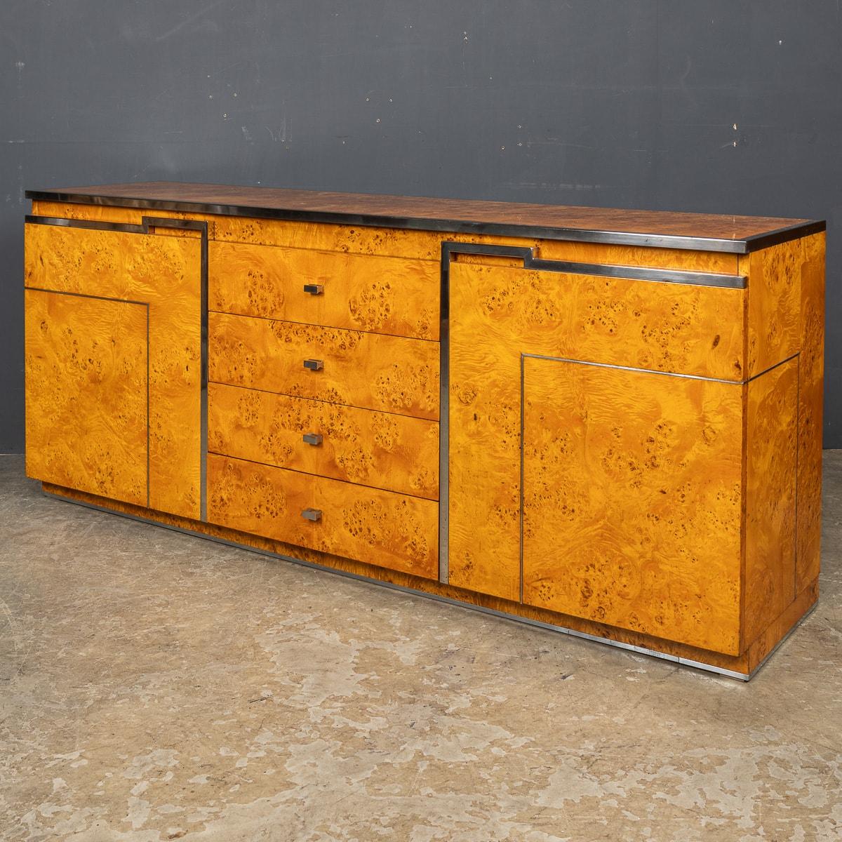 A stunning 20th Century credenza finished in pollard oak with the addition of polished nickel edges and hardware. This piece has four drawers and a cupboard at either end. The reverse side is also finished in the same style so this piece can be used