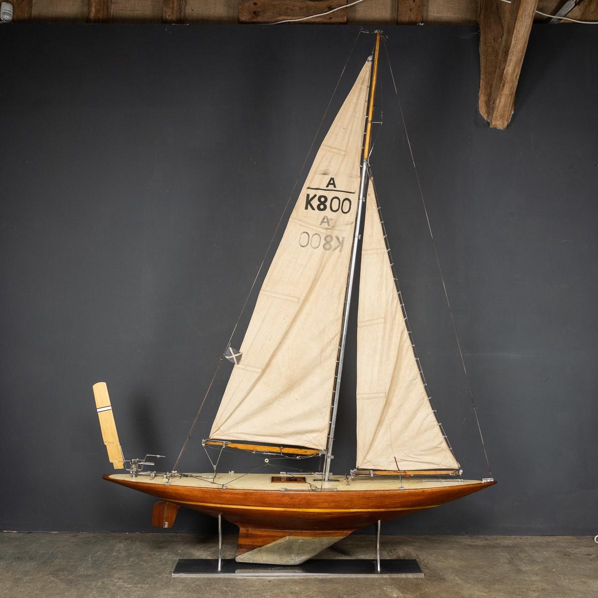 Registered as A K800, this pond yacht with a plank on frame hull, made in mahogany and cream painted plank lined deck. This classic A Class yacht would have been made in the 1960's by two or more people adhering to strict planned guidelines. This