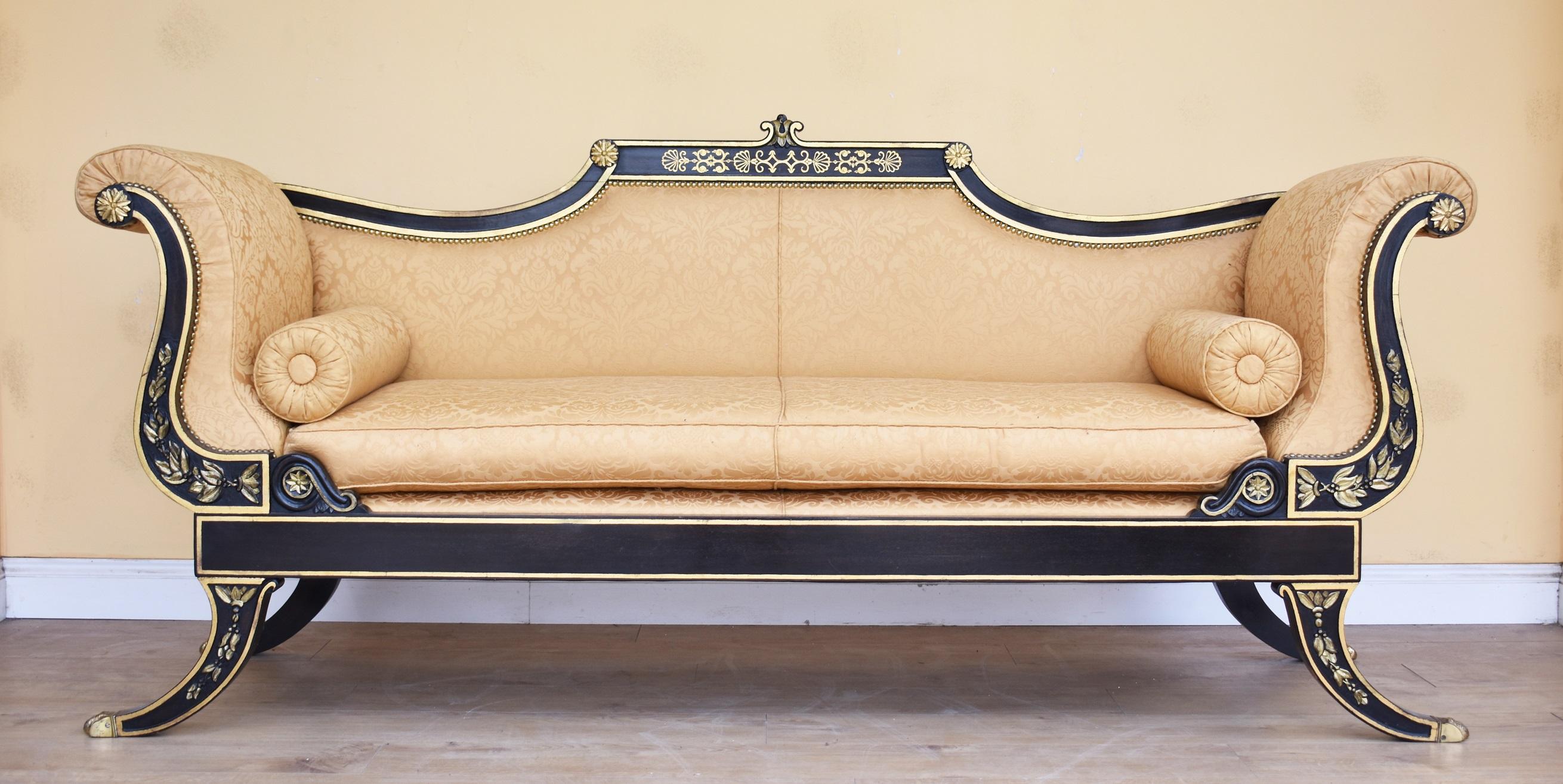 For sale is a very good quality 20th century English Regency style ebonised parcel-gilt three-piece suite, with pad backs having scroll arms and cushion seats, upholstered in lemon damask, raised on sabre legs. The whole suite is in very good