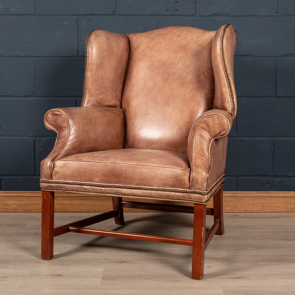 A lovely example of English leather craftsmanship. Dating to the latter part of the 20th century, this leather wing-back armchair has a beautiful tan colour, great proportions and lovely patina.

Condition
In Good Condition - wear and tear
