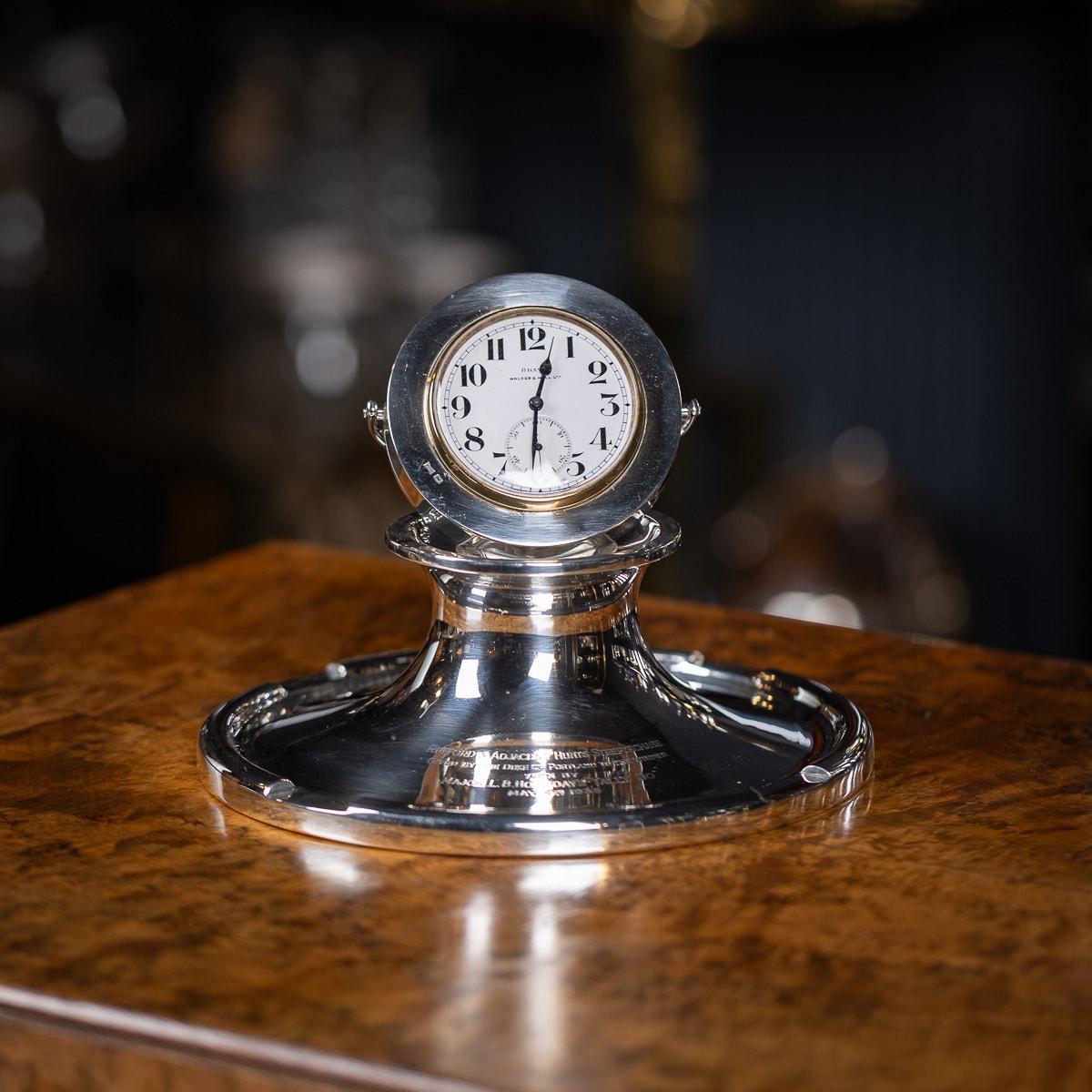 A superb 20th-century English solid silver capstan shaped desk clock and inkwell, crafted by Walker & Hall. This inkwell was awarded as a trophy to 
