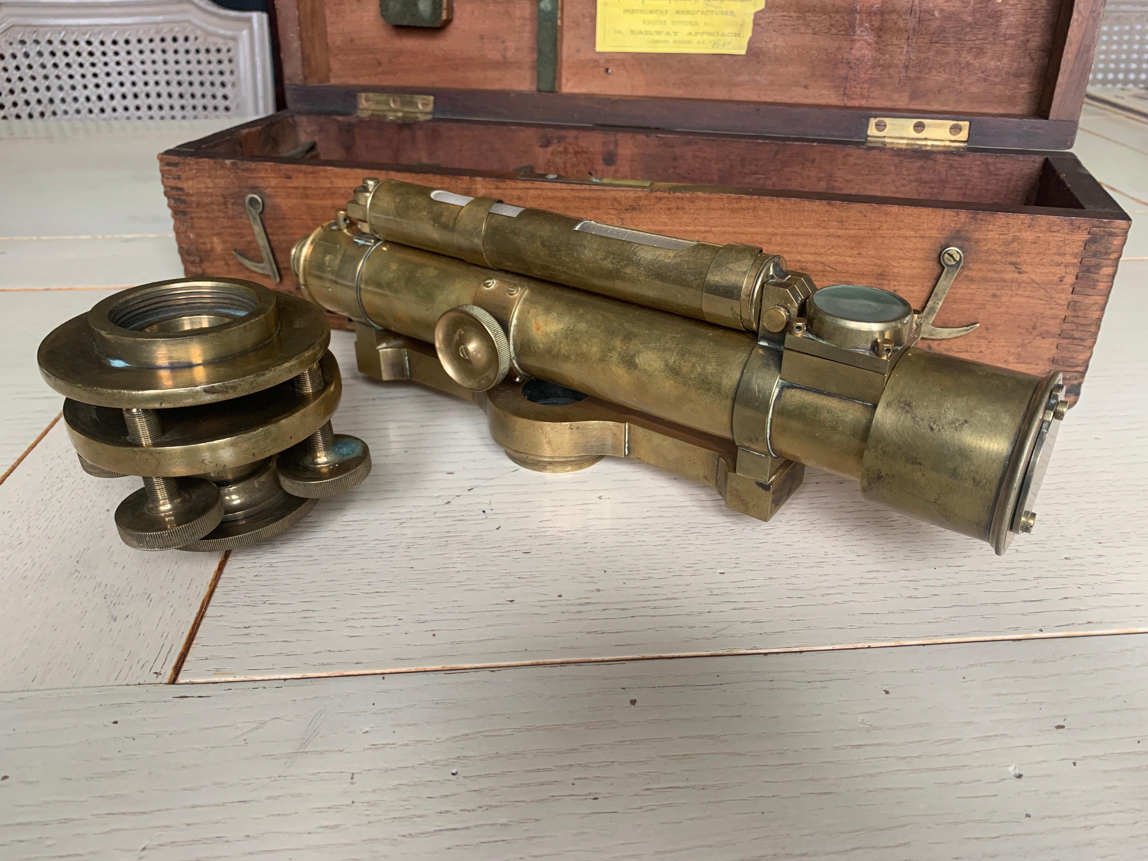20th century English surveyor's theodolite or transit instrument of brass by W.F. Stanley (Optical, Philosophical & Mathematical Instrument Manufacturer, London), circa 1930, in original fitted wooden box. With attached spirit level on