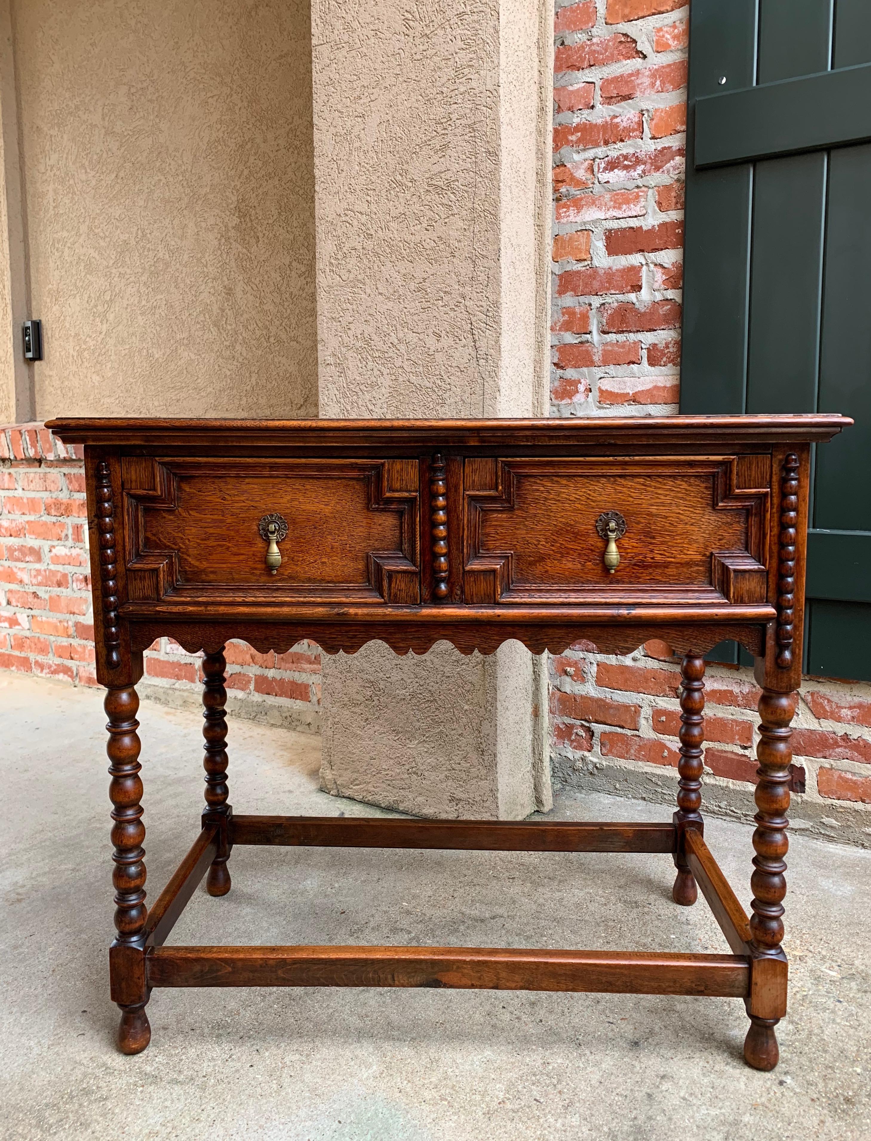 Direct from England, a lovely and versatile antique English tiger oak sofa or hall table~
~Classic English bobbin legs (front and back) and venerable British style, certain to compliment any placement in your home!~
~Two geometric, Jacobean style