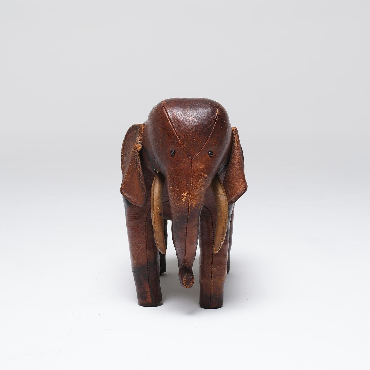 A vintage English leather elephant by Dimitri Omersa in good condition. The elephant is a wonderful example that boasts rich color and detailed construction, designed in the 1970's for Abercrombie and Fitch. Minor fading, due to age. Wear consistent