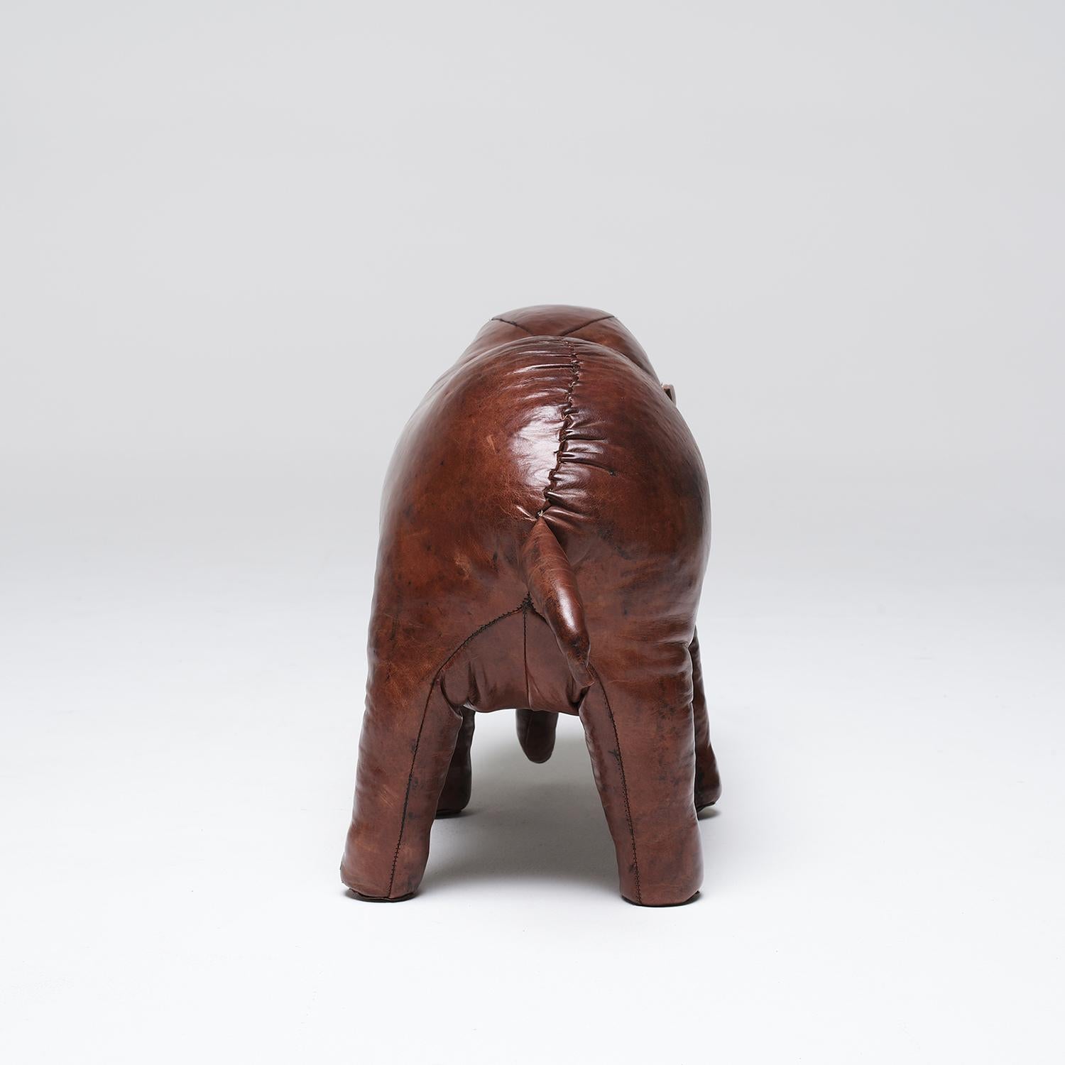 A vintage English hand crafted leather footstool in the shape of an elephant designed by Dimitri Omersa. Minor fading, due to age. Wear consistent with age and use. Circa 1970, United Kingdom.

Dimitri Omersa was born in Yugoslavia. He came to