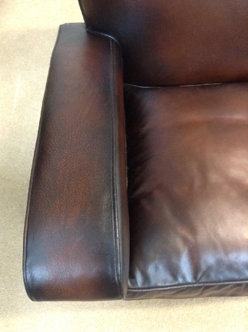 For sale is a good quality retro/vintage two-seat leather sofa which has been recently restored. The sofa has its original leather on both arms, front facings, seat border and piece along top of seat back, which show signs of age but are not