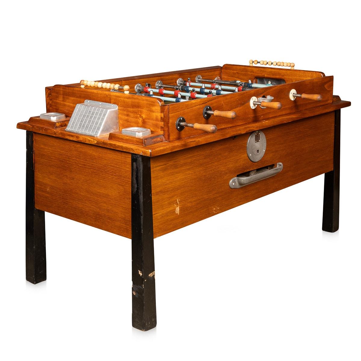 This mid-20th-century foosball table, with its captivating two-tone color scheme of black legs and a hardwood body, embodies an era when it was a centerpiece in Italy's bustling Martini bars throughout the '50s. Amidst the clinking of glasses and
