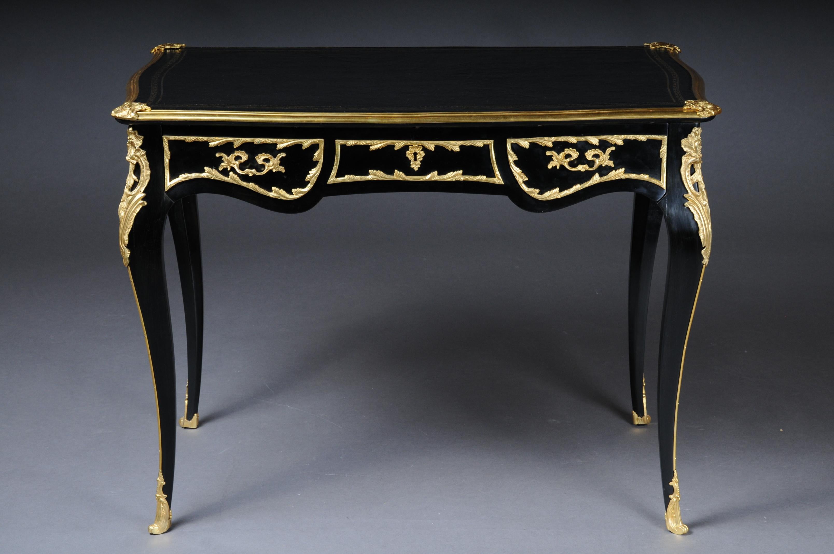 20th century exclusive bureau plat/ writing desk in Louis XV style

Solid beechwood ebonized/blackened. Very fine, floral bronze fittings. Frame base with four-sided curvature. 3 drawers and wide knee compartment ending on elegantly curved square