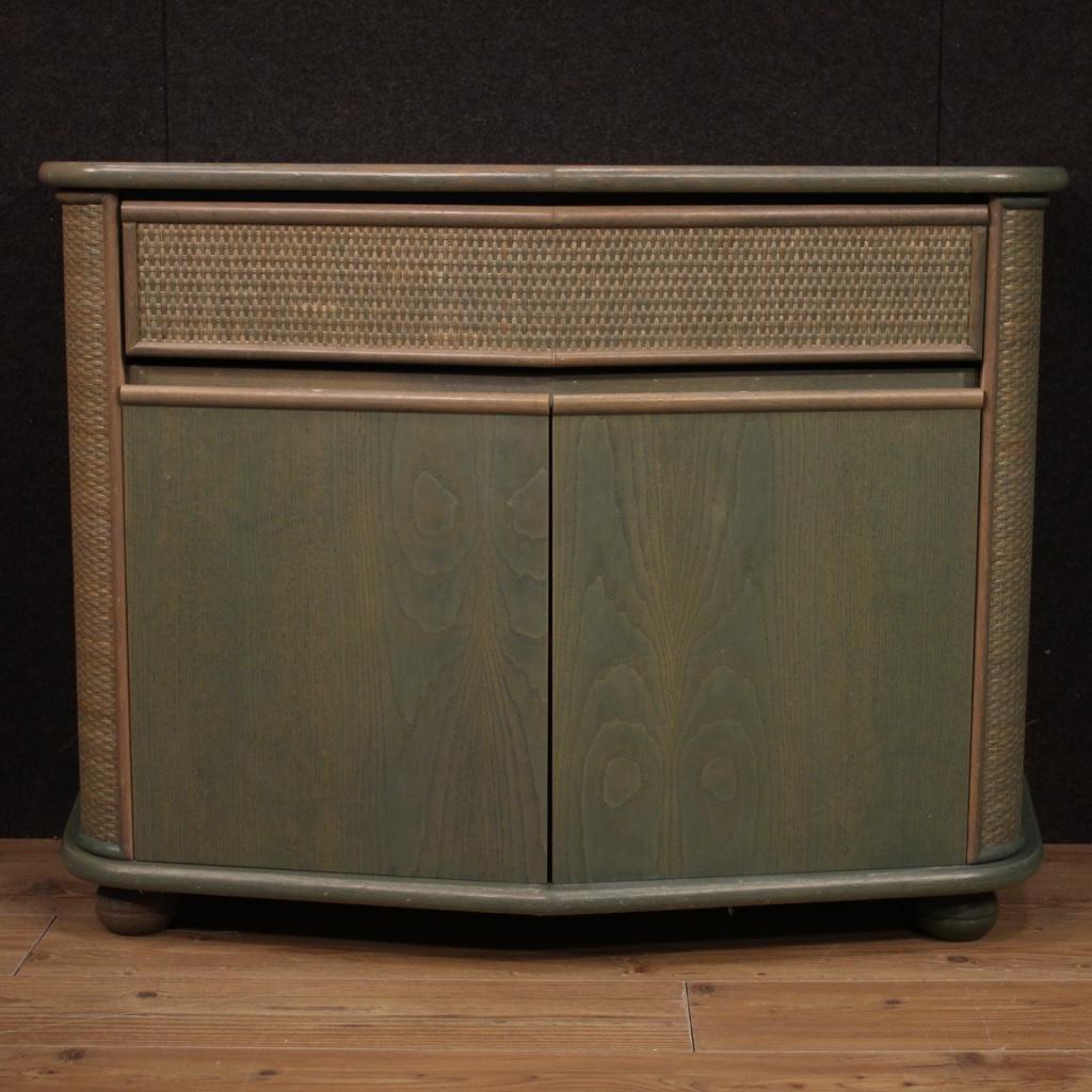 Italian design sideboard from the 1980s. Exotic wood furniture adorned with woven wood on the sides and on the front of the drawer, of beautiful line and good utility. Sideboard with two doors and a drawer with wooden top in character. Beautifully