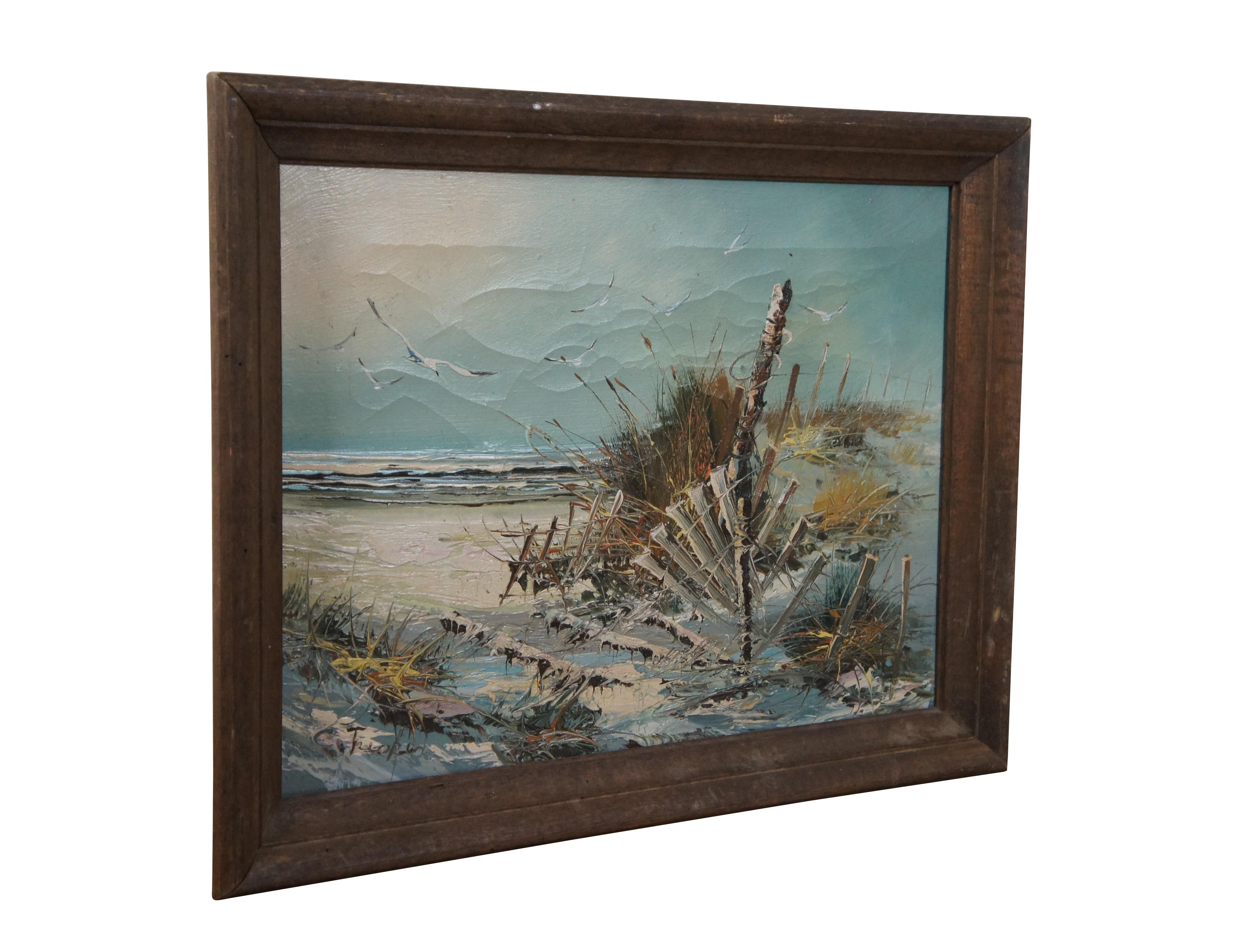 Vintage oil on canvas expressionist coastal landscape painting depicting a white sandy beach with a dilapidated fence perched on a grassy dune and seagulls flying above. Signed in lower left corner. Framed in a simple beveled wood