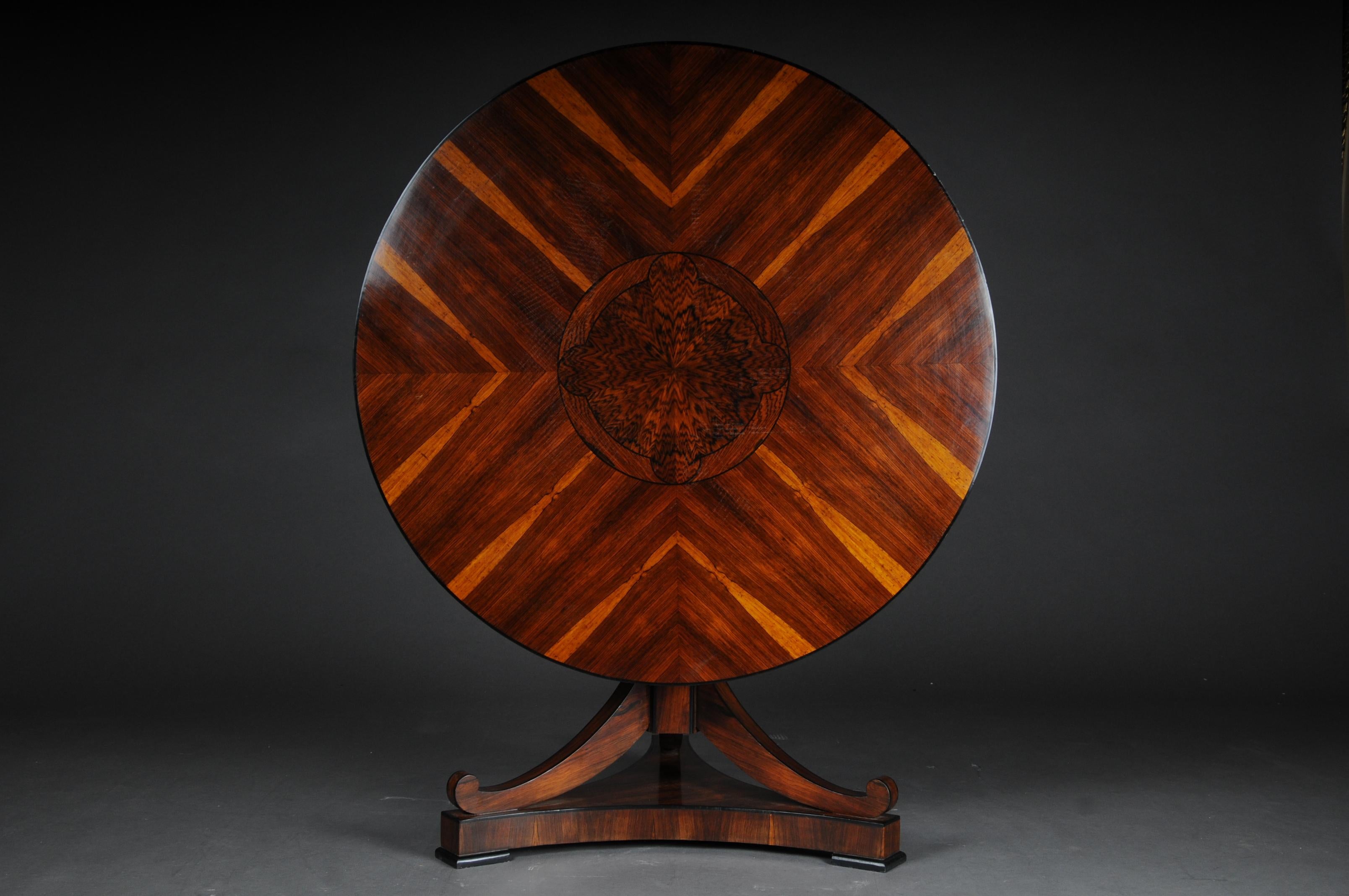 20th century Fancy round folding table in Biedermeier style

Maple root on solid wood. Ebonized ribbon and thread inlays. Base plate drawn in on three sides on disc feet. Column shaft rising in the middle, eight-fold edged, flanked by three curly