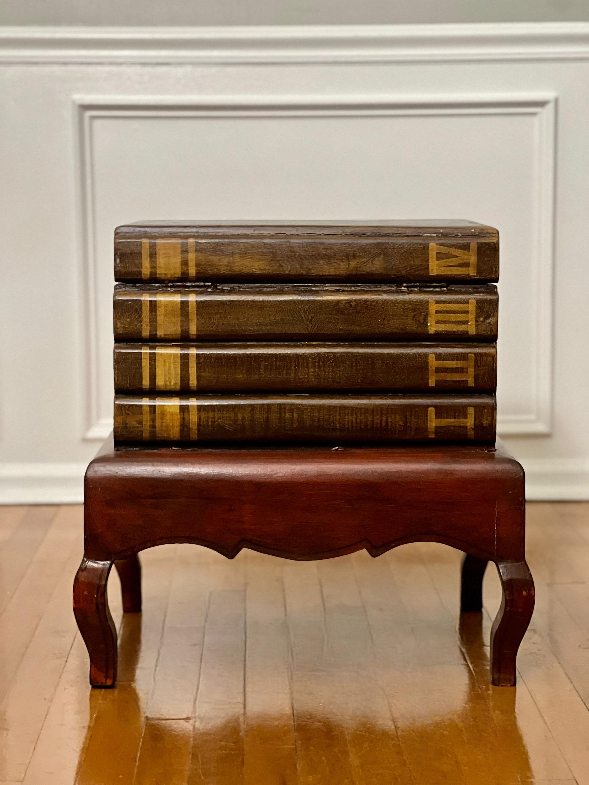 Charming faux stack of books table with full-length portrait of a girl and lift-top storage. The painted stack has a hinged top with Roman numeral volume markings and a nicely sized interior storage cabin resting on a shapely base. Great table to