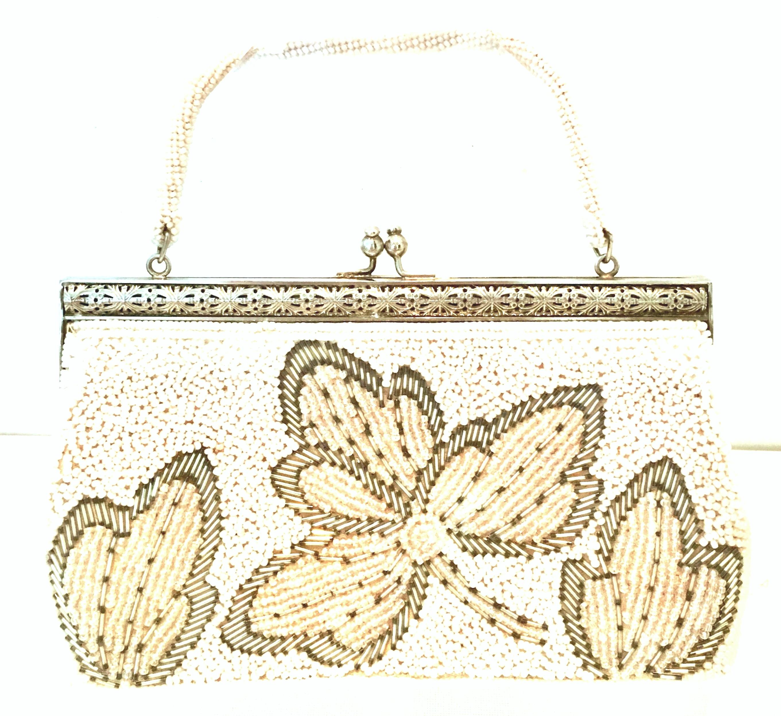 20th Century faux pearl & silver glass hand beaded Hong Kong evening bag. This rare floral motif Hong Kong bag features shimmering,  tiny pearl ascent white beads with iridescent faux pearl beads and silver glss beads in a raised floral double sided