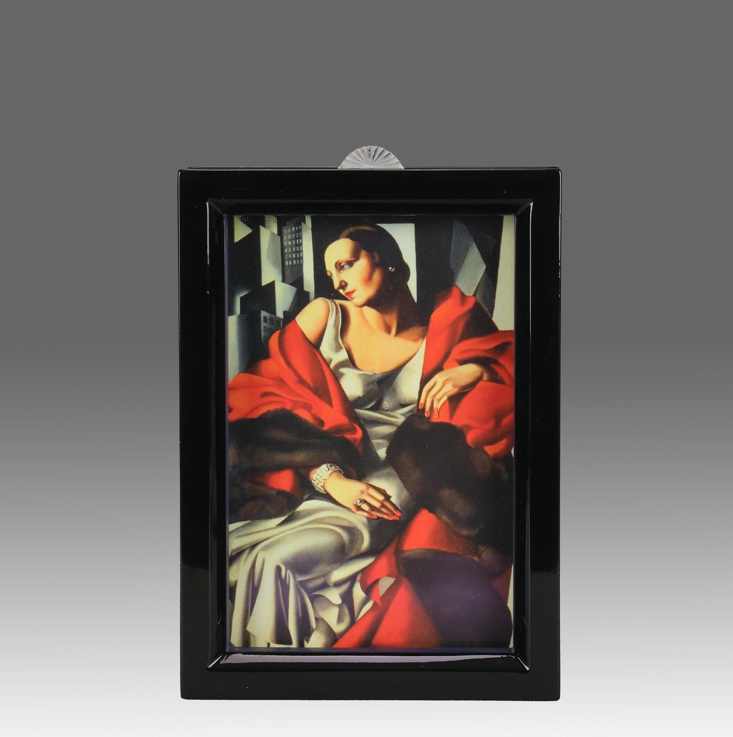 A very fine black lacquered wood photograph frame etched with a lilac blue floral cherry branch decoration to the sides of the case and finished with a crystal glass finial motif, marked Lalique

ADDITIONAL INFORMATION
Height:                       