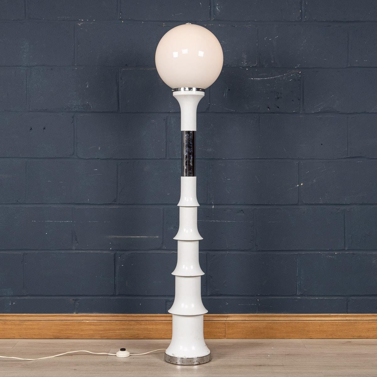 A very rare floor lamp by designed by Enrico Tronconi for Vistosi in Italy, manufactured around the 1970s. The glass illuminating sphere is secured over a bamboo-like metal lacquered frame with chrome detailing. A wonderful piece of midcentury