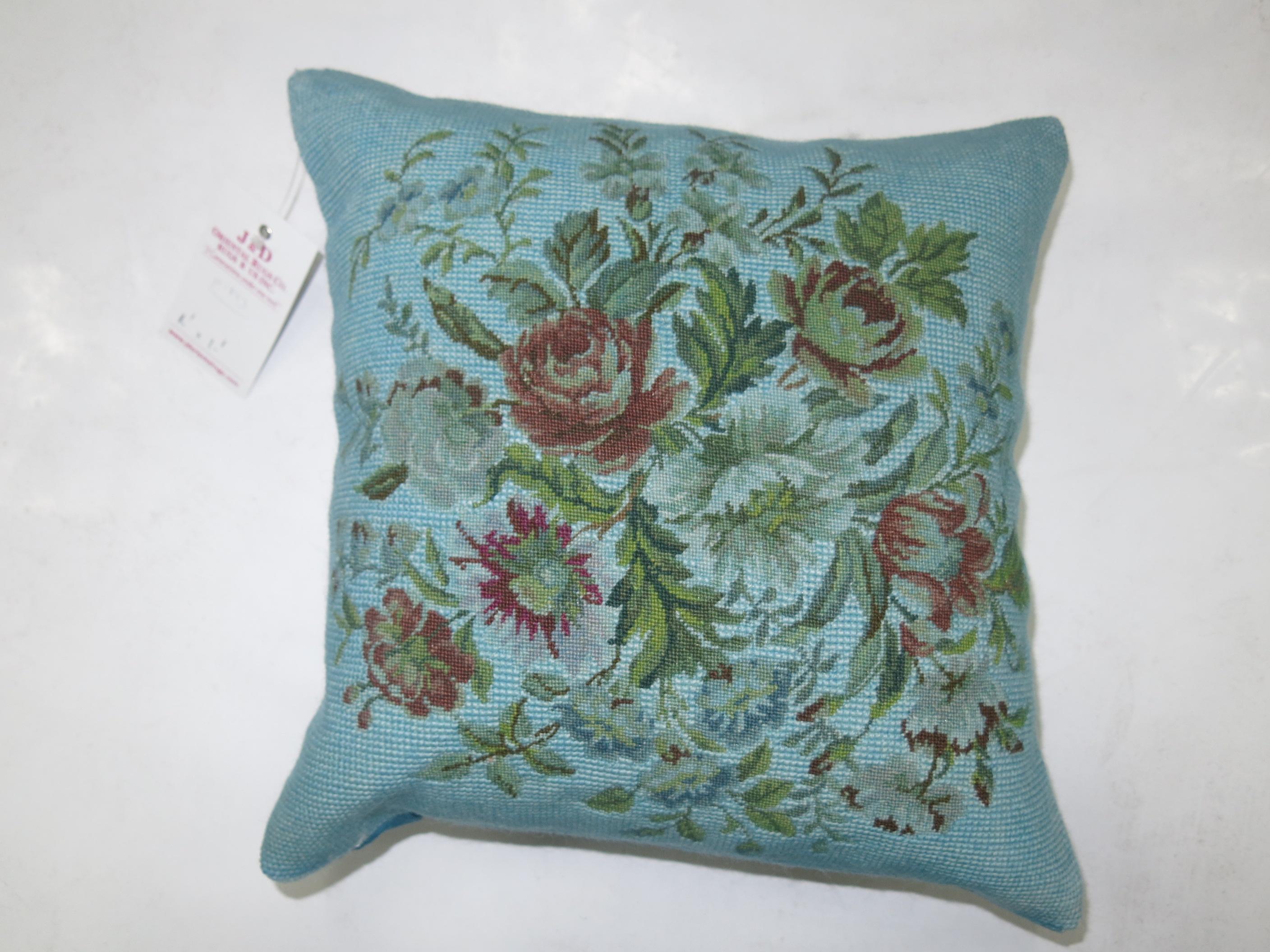 Pillow made from a 20th century French needlepoint with blue cotton back and zipper closure.

Measures: 13