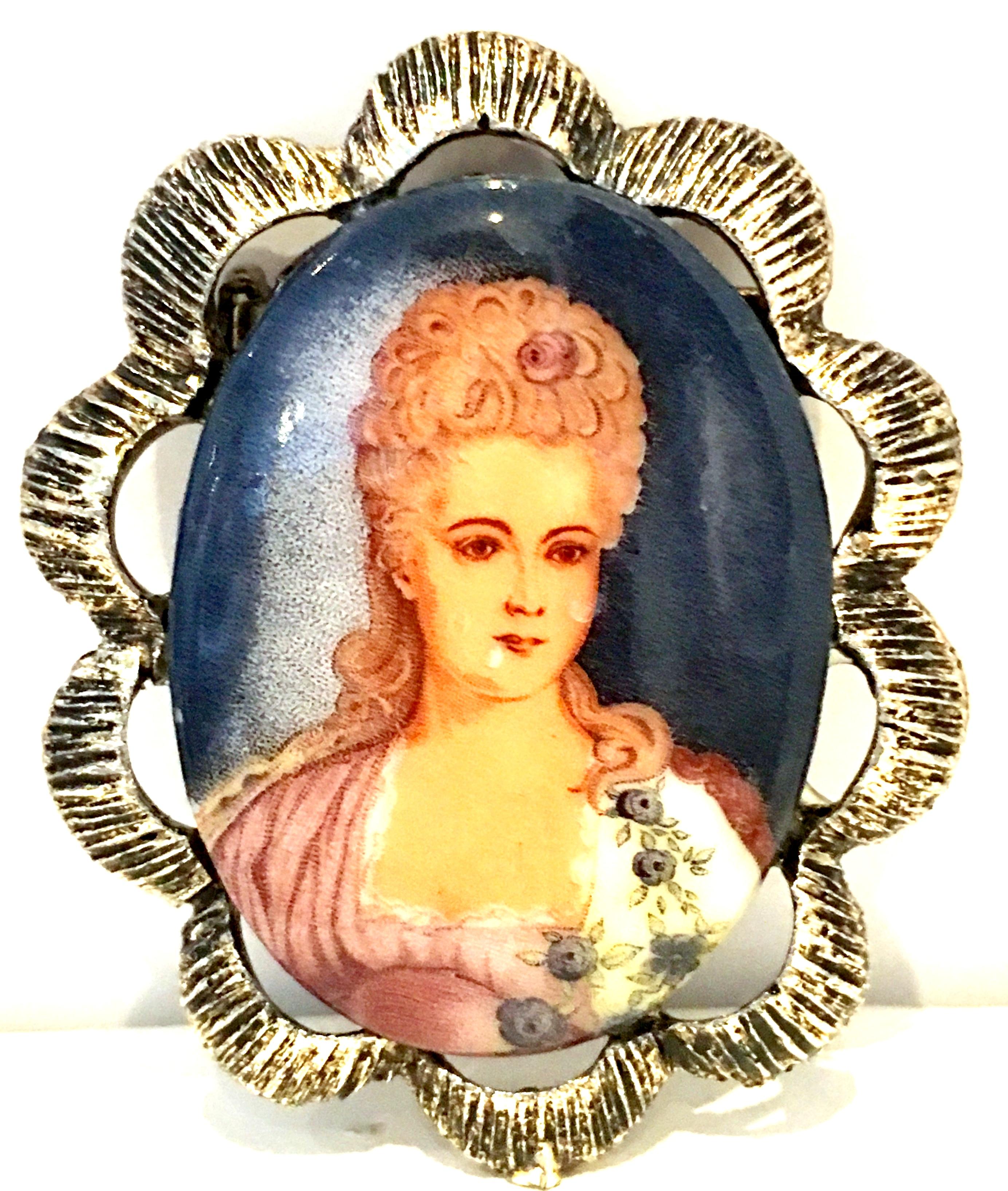 20th Century Florenza Style Silver Plate Hand Painted Portrait Brooch. This Victorian style brooch features a silver plate ornate frame with a hand painted ceramic female portrait.

