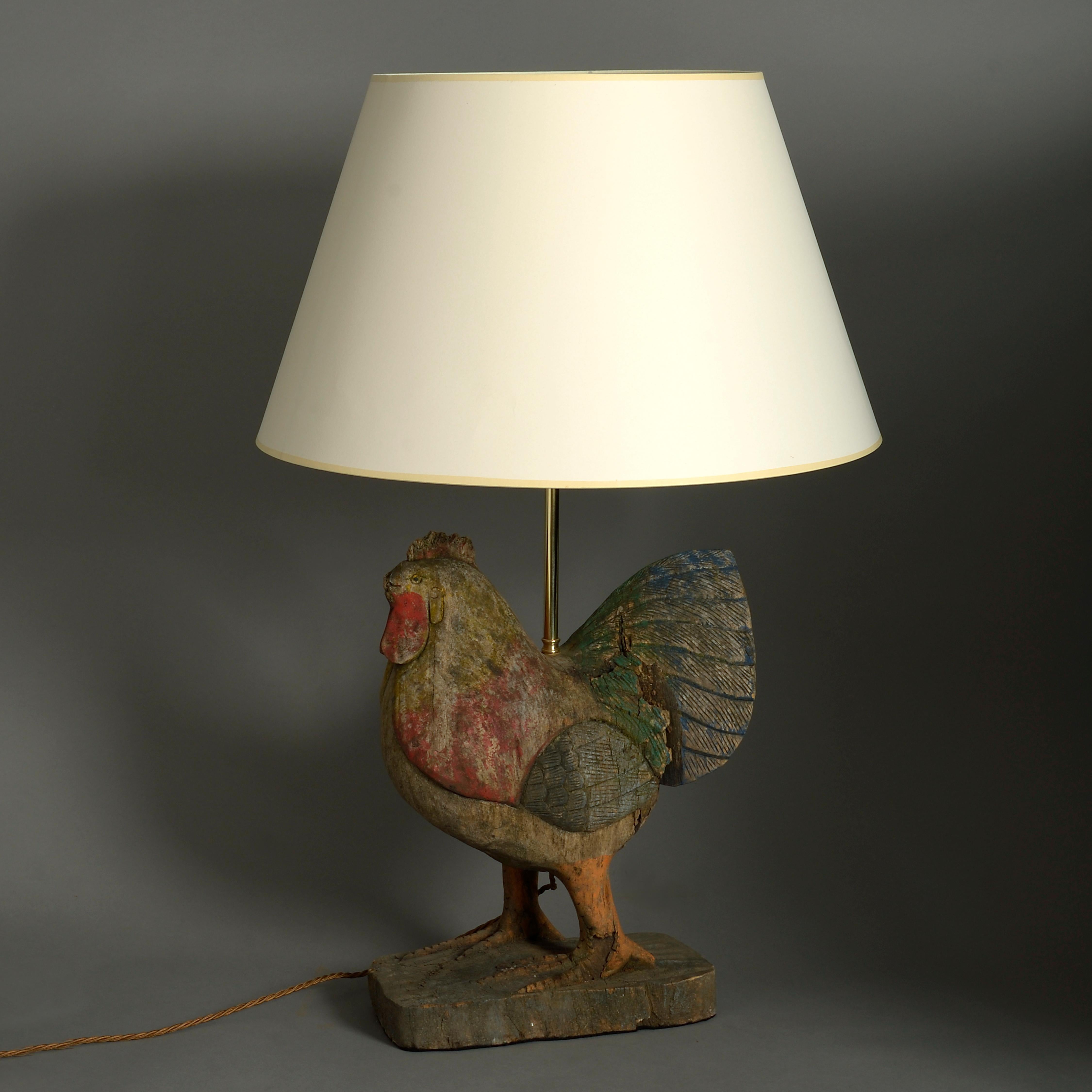 A charming mid-20th century carved and polychrome cold painted Folk Art rooster, set on a plinth and now wired as a lamp base.

Height dimension refers to bird only and does not electrical parts.

  