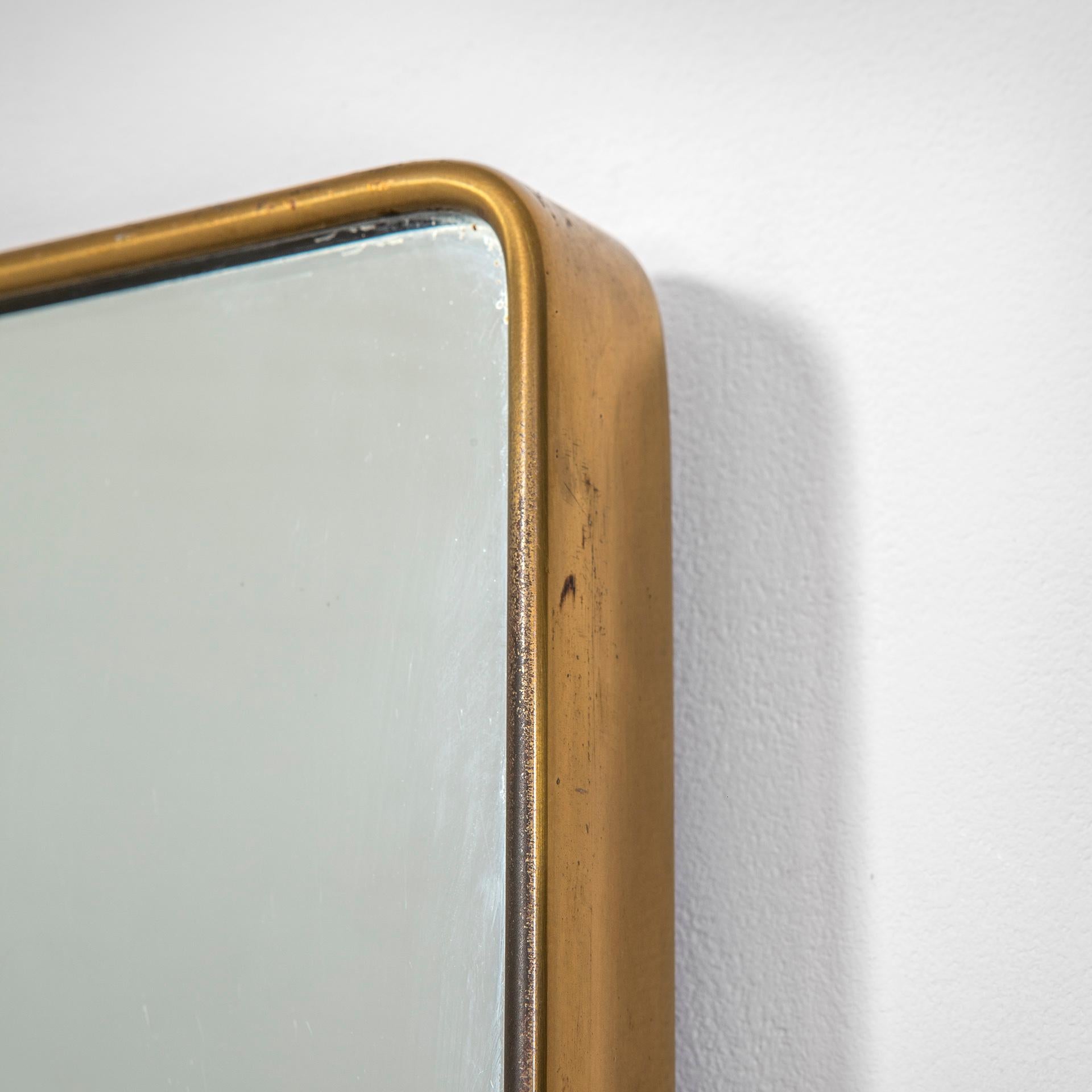 Fontana Arte mirror from the 1950s with brass edge and manufacturer's trademark on the back as “Galvanit Fontana Cantù 1954” . 
This mirror is a must have of the Italian Design, this is an item timelss and fitting always good with all kind of