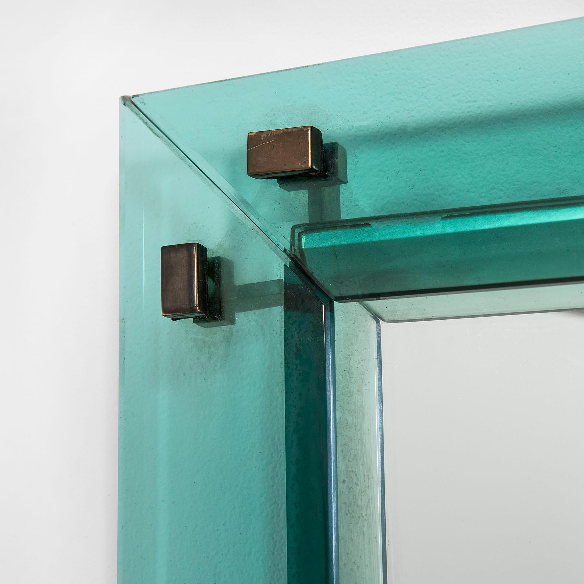 Wall mirror designed by the Master of Glass Max Ingrand for Fontana Arte in '50s. The mirror has a wonderful frame in colored and ground crystal, the colour is a light blue. The mirror itself is behind the frame. The frame is decorated with little
