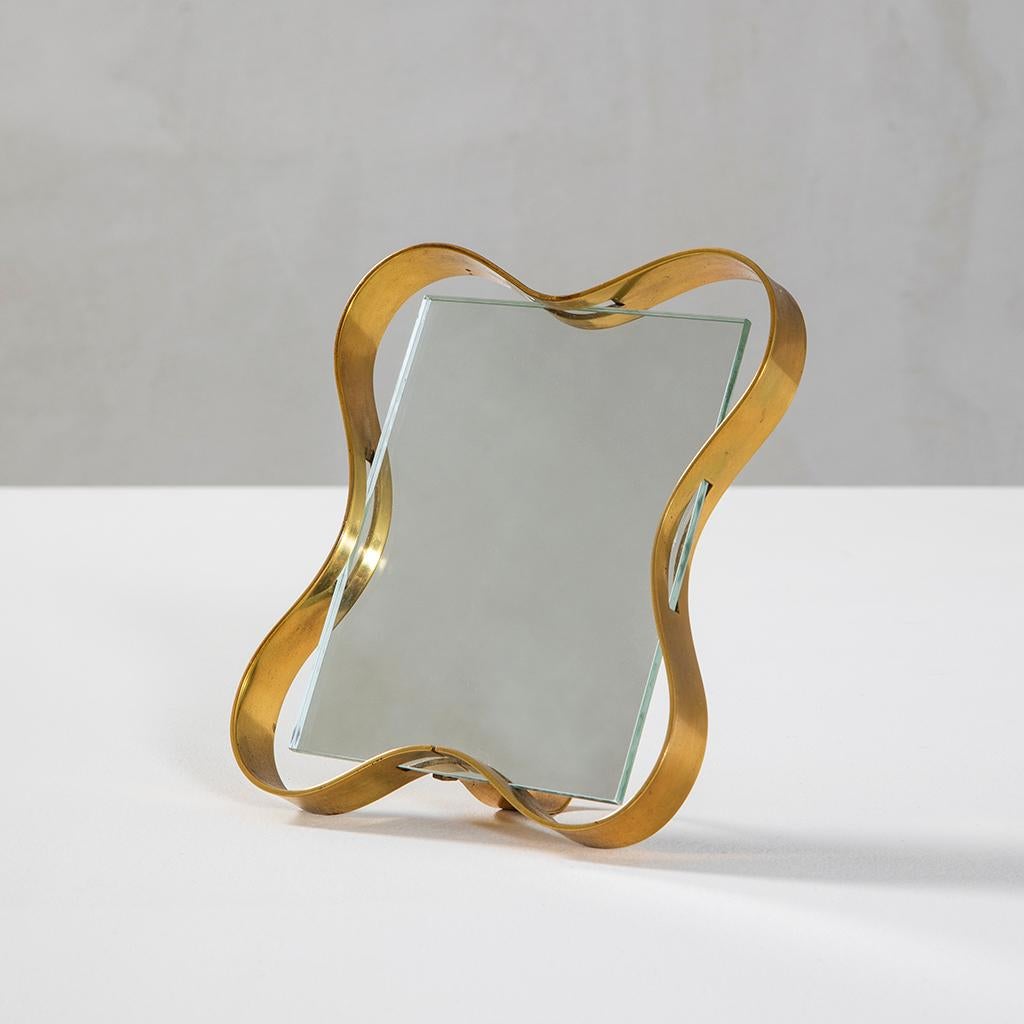 Very beautiful Table Mirror by Fontana Arte. Designed in '50s, the mirror has a very peculiar Brass frame. It could be perfect for the boudoir or the bedroom, or even for the walk in closet.
Actually, everywhere you will need to face
