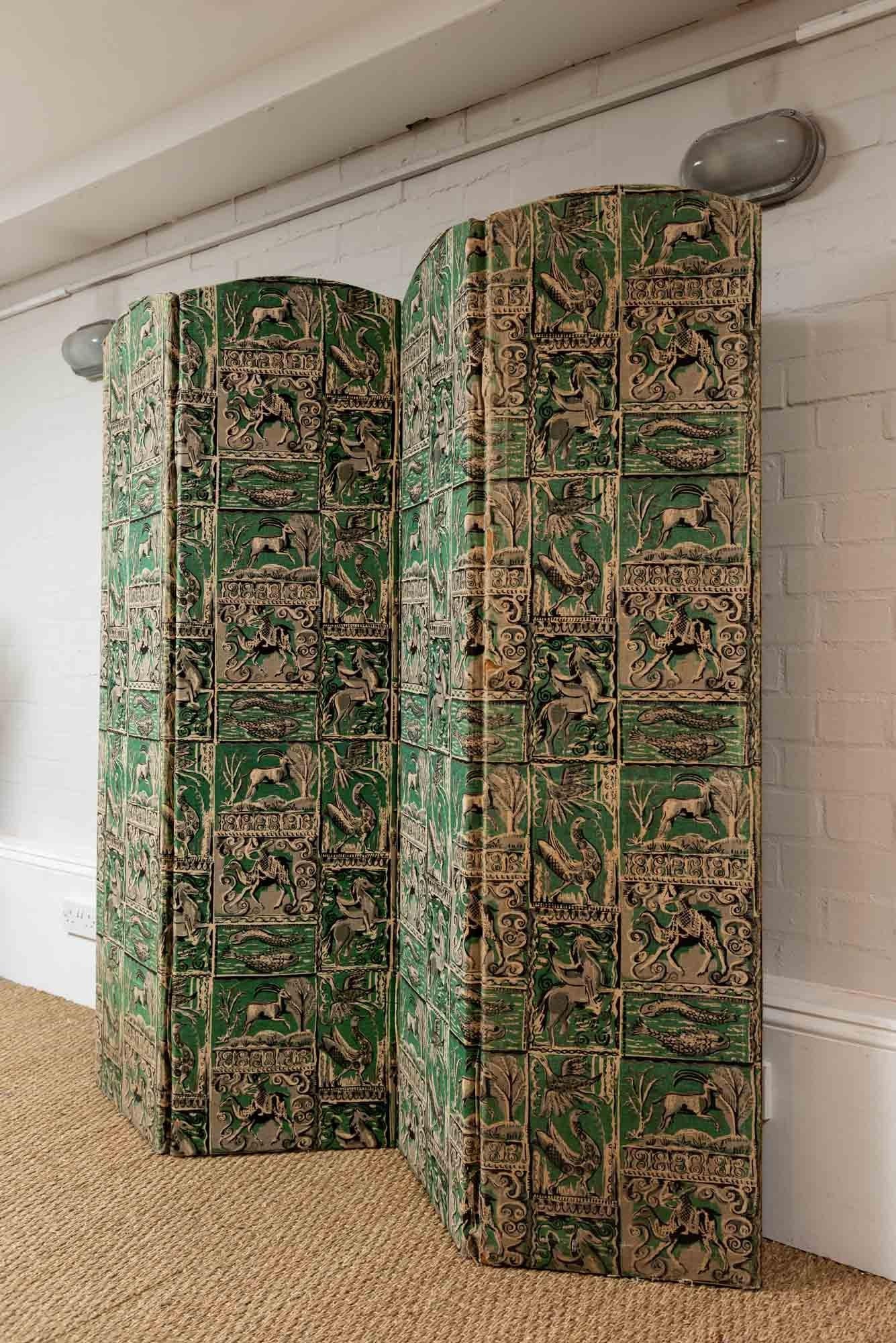 Beautiful four-fold printed floor standing screen in the style of Edward Bawden, circa 1930s. The screen is in a vivid green which is covered on both sides and features an unusual and interesting horoscope print design.
