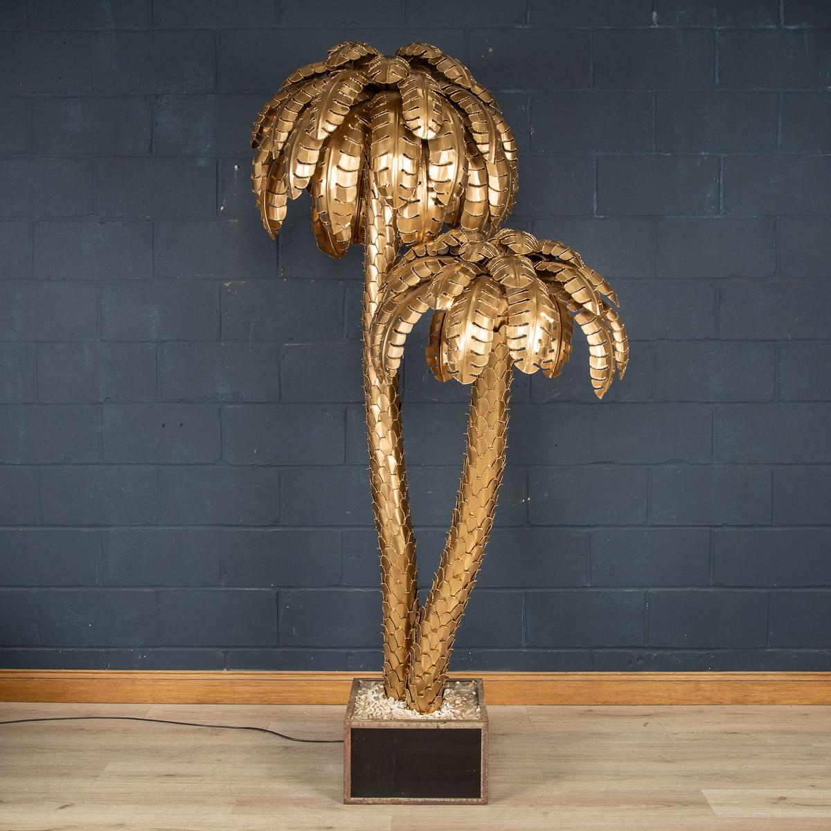 A massive and very rare Maison Jansen palm tree floor lamp dating from the 1960s/70s, with eight light points. The lamp has been constructed by hand using brass sheets overlapping each other to mimic the leaves and trunk of the plant. Of fantastic