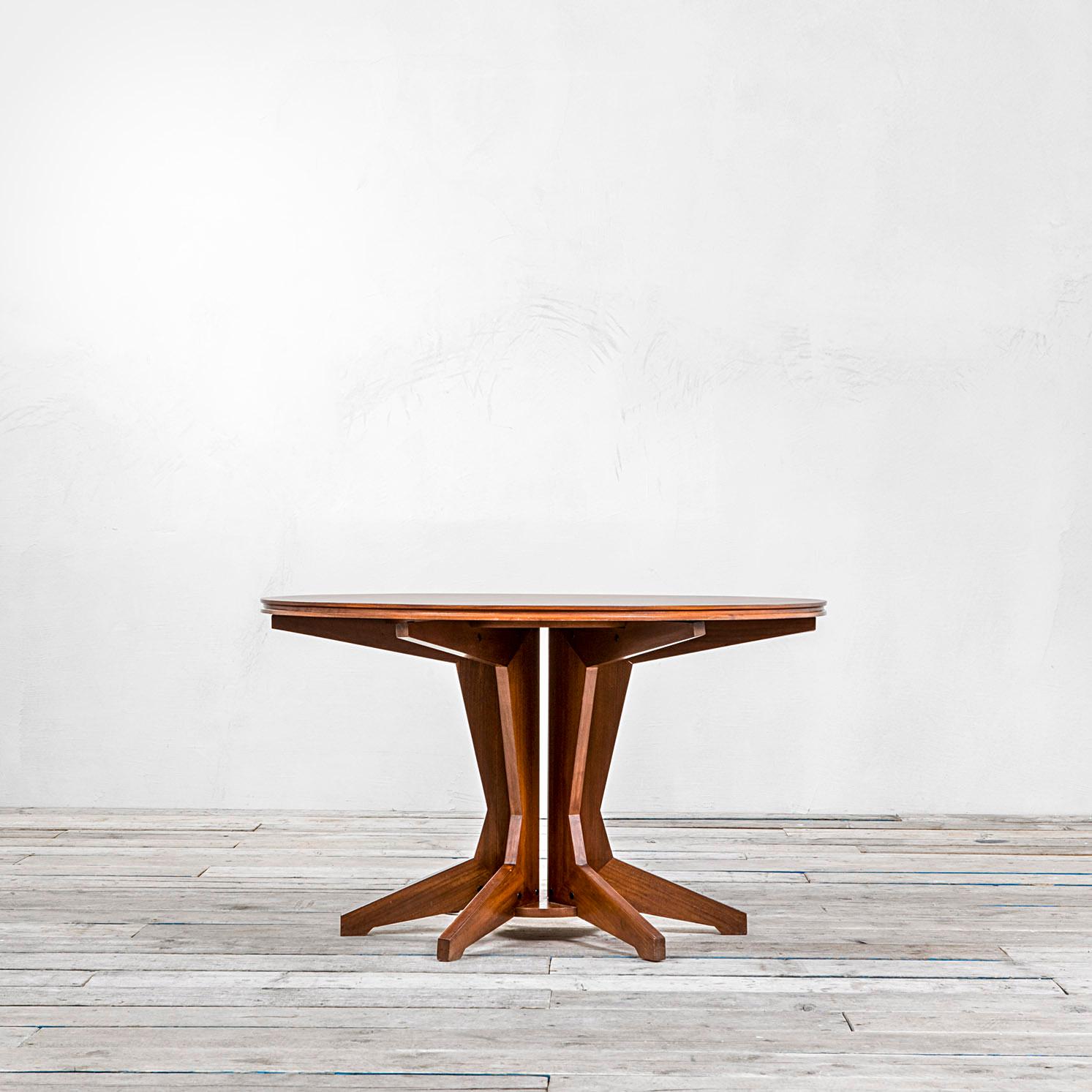 Wooden table with round top and base with radial elements designed by Franco Albini and manufactured for Poggi. 