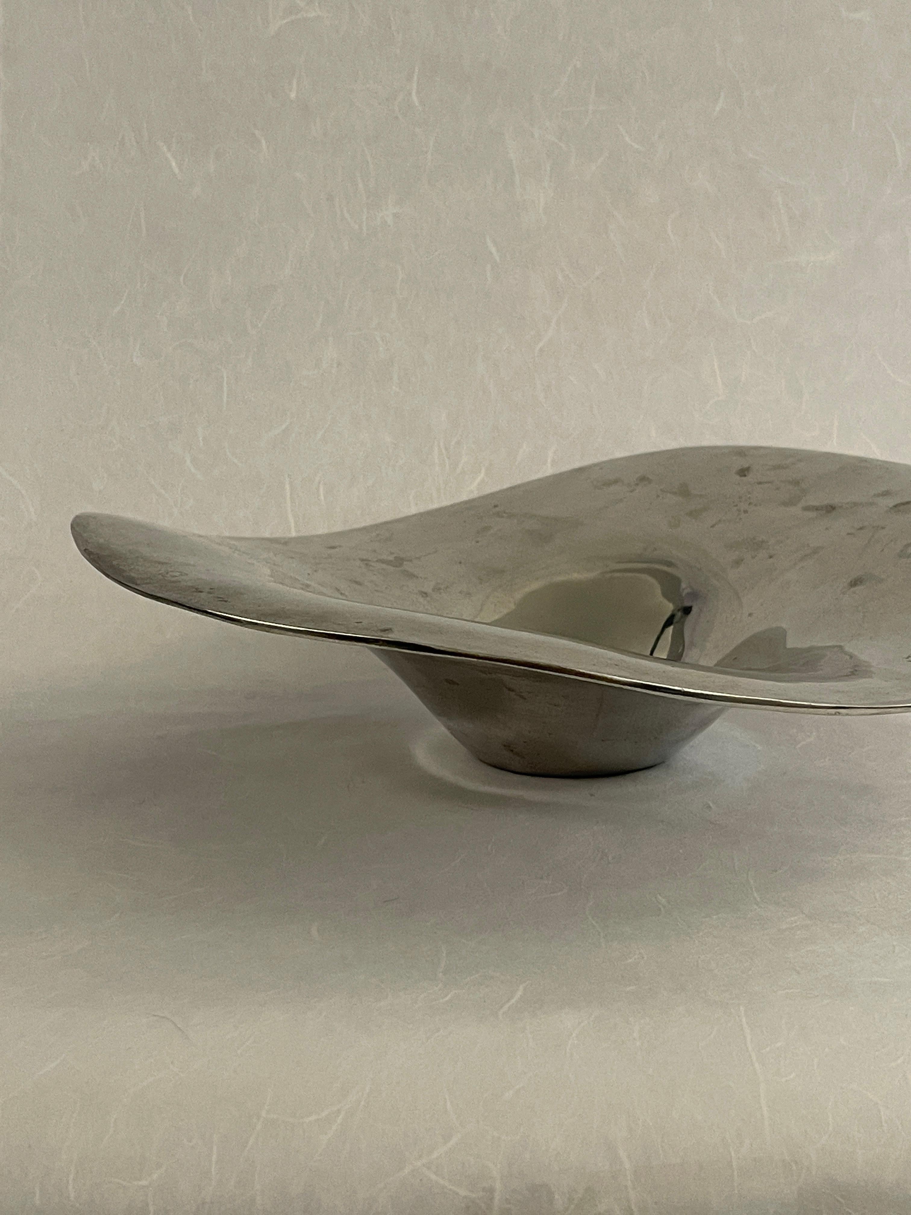 20th Century freeform stainless catchall centerpiece bowl in an abstract shape. Beautiful shiny finish with a fluted opening perfect for any centerpiece or display catchall. Surely an eye catcher.