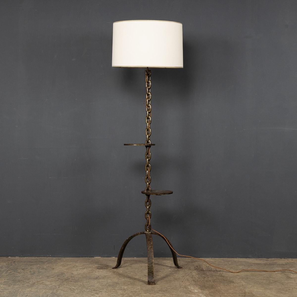 An elegant and unusual freestanding lamp with 2 integrated shelves in the stand, made in France around the 1930's. The lamp stand is made from metal taken from a French boats iron anchor chain. Feet were added along with a stylish lampshade