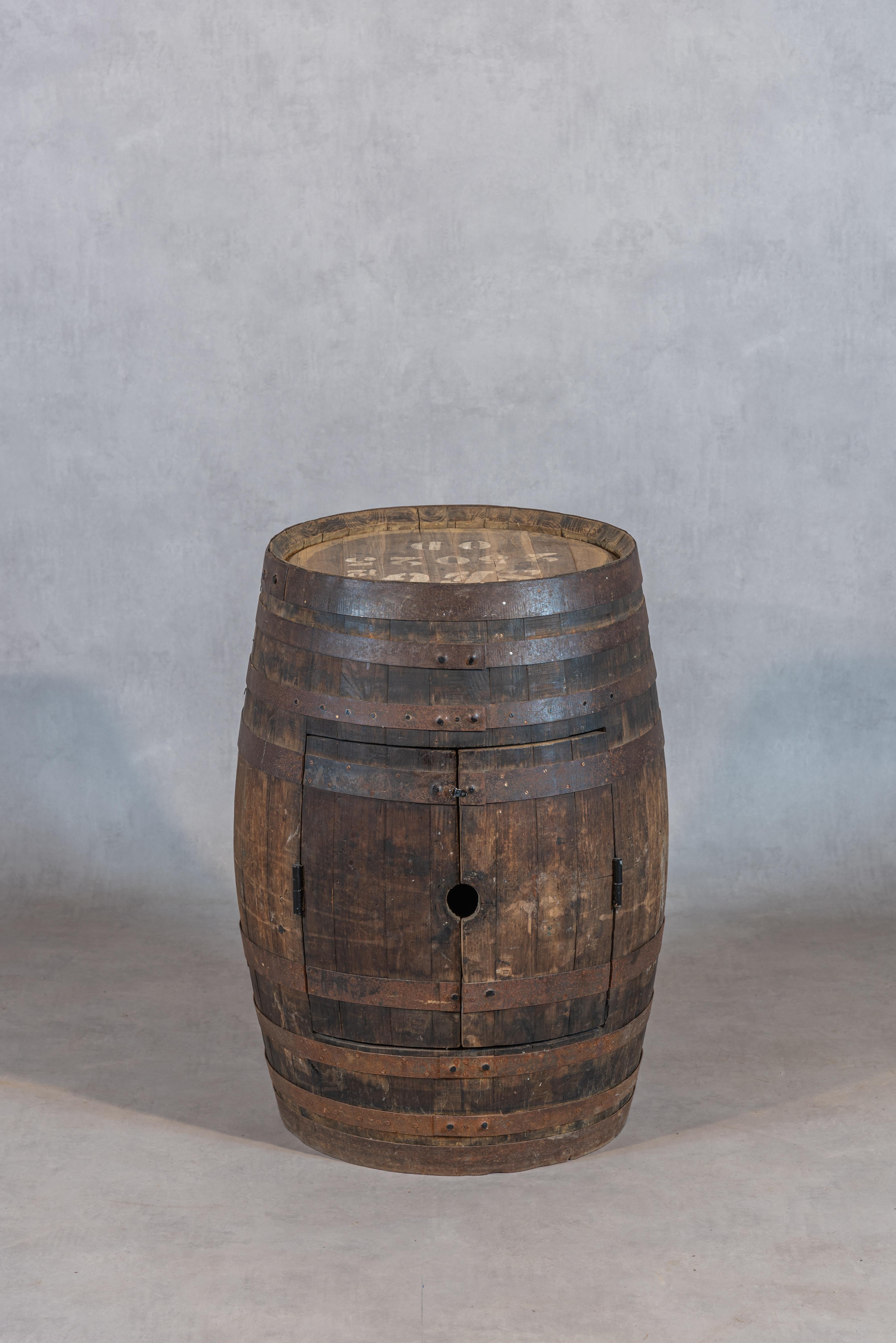 Indulge in the timeless charm of a superb 20th-century French antique barrel bar or Tonneau, a captivating piece that evokes the rustic allure of French chateaux wineries. This exquisite barrel exudes vintage appeal with its charming, weathered
