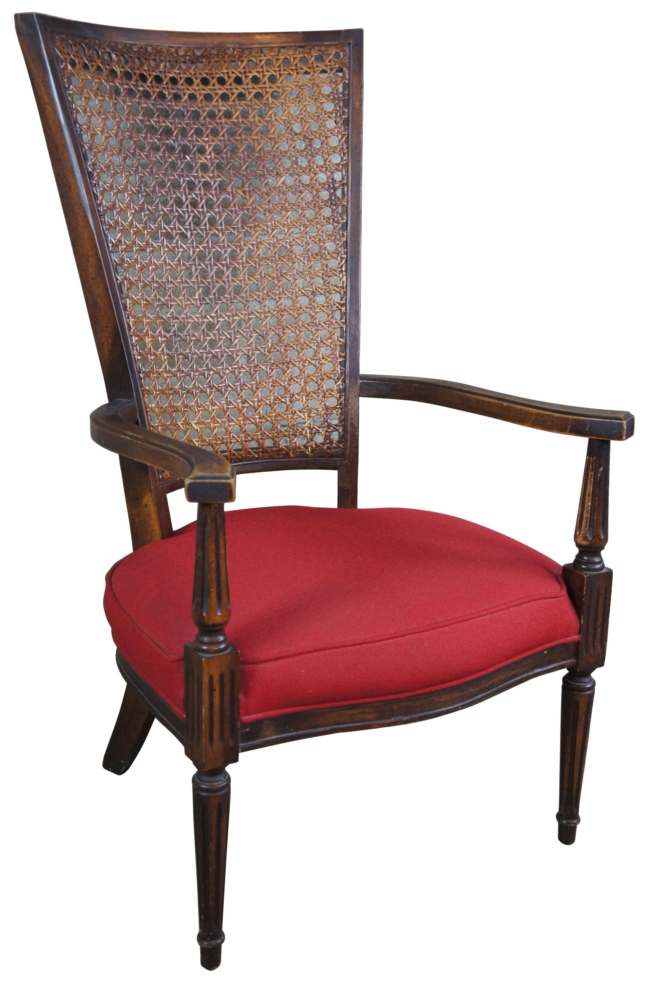 20th century French caned back armchair. Features flared arms over tapered fluted supports, leading to tapered feet. Measures: 42