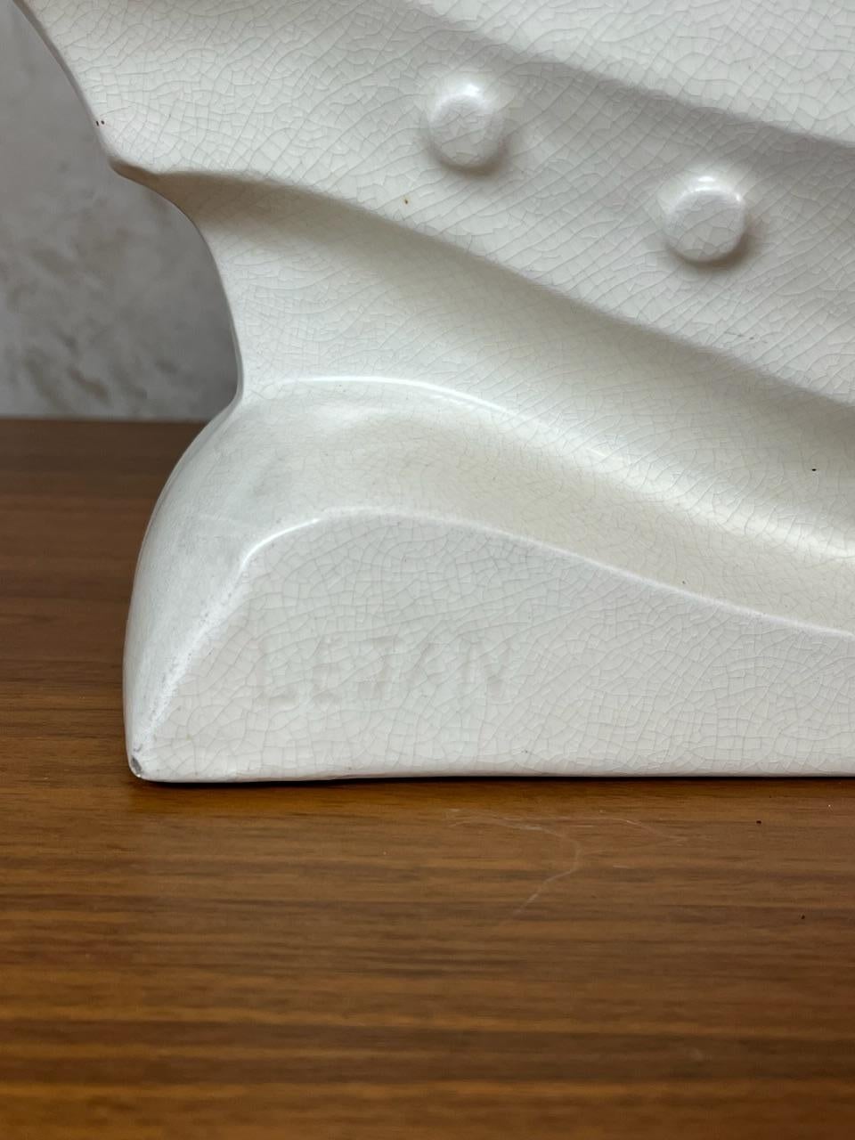 Art deco Lejan “Bateau à cavalière” in white crackled ceramic, featuring an artisanal and timeless 1920s style. A decorative piece, perfect for a shelf, coffee table, or display cabinet.

Features:
Material: Glazed ceramic with crackled