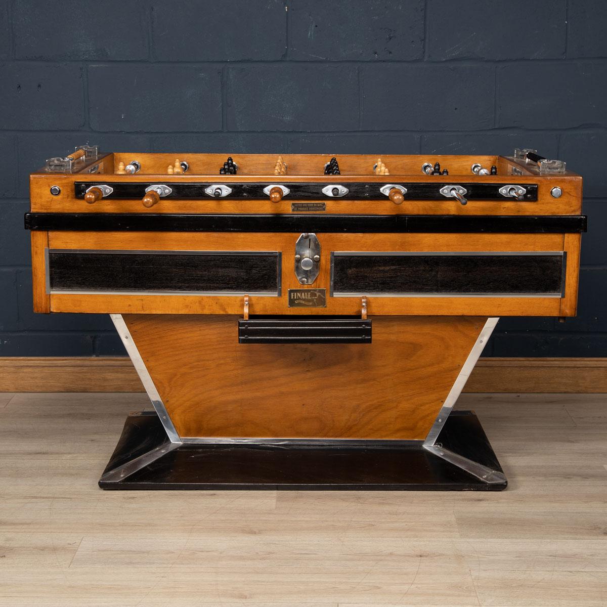 Beautiful French table football game (also known as a foosball table), early to mid 20th century. Painted and varnished wood and chromium plated and other metals, each side with four wooden-handled rods, the footballers of painted wood, a label to