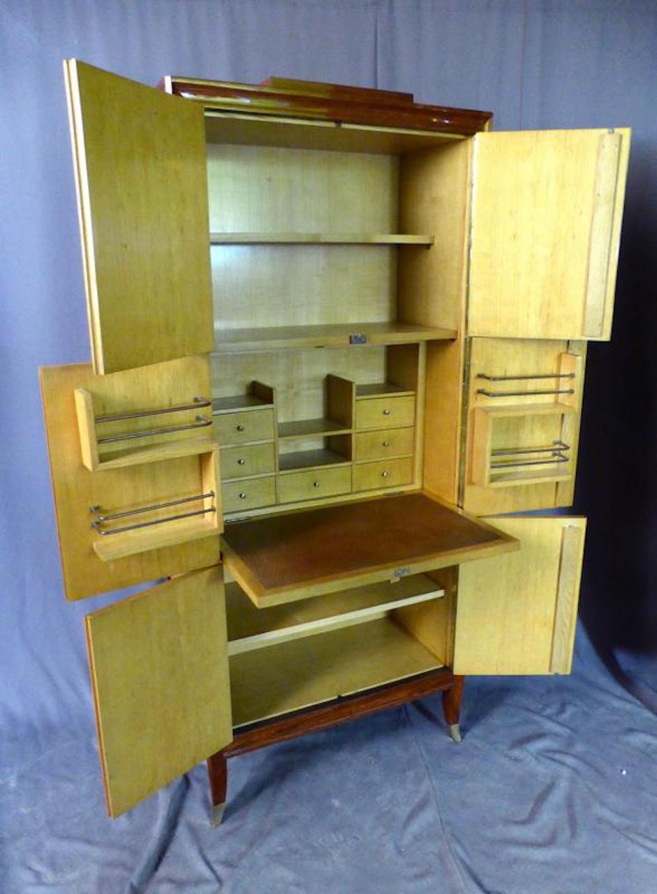 Exceptional Art Deco pair of cupboards forming a secretary in rosewood and sycamore. 
The base ends with bronze shoes.
These two pieces of furniture are rare quality with multiple storage combinations. 
The cabinetry is perfect and the