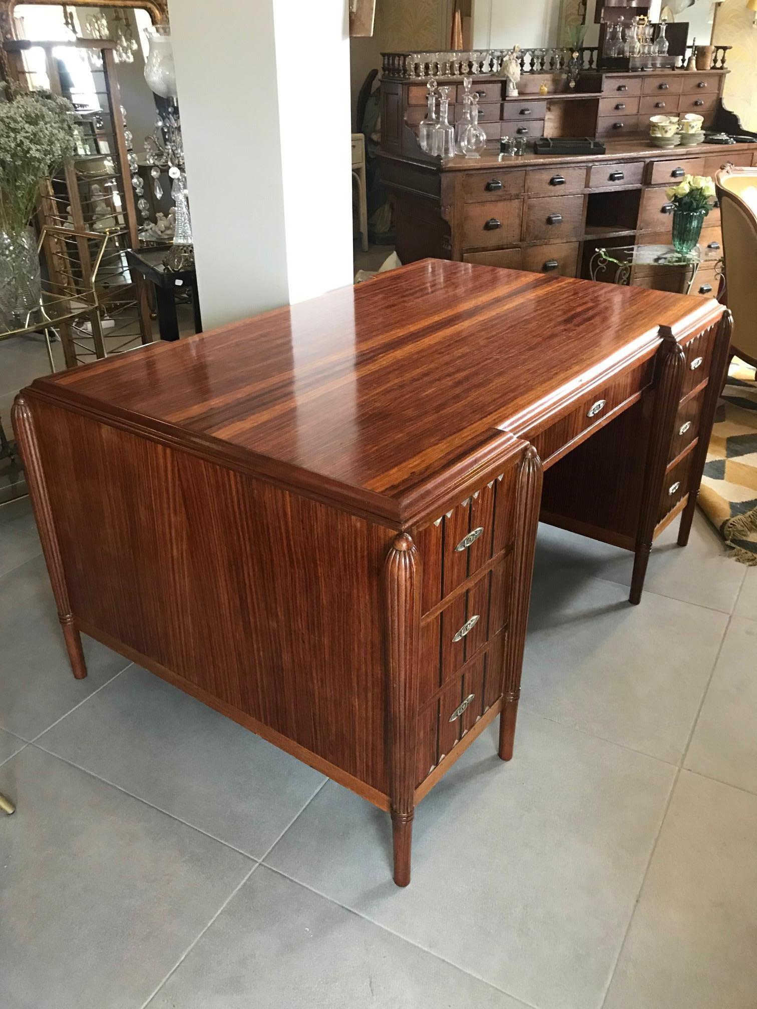 Beautiful and rare 20th century Large French Art deco rosewood, Elm Burl and mother of pearl inlay Desk from the 1930s. Very good condition. Mother of Pearl inlay at the top of the drawers. Seven drawers. 
Six original keys. The patina has been