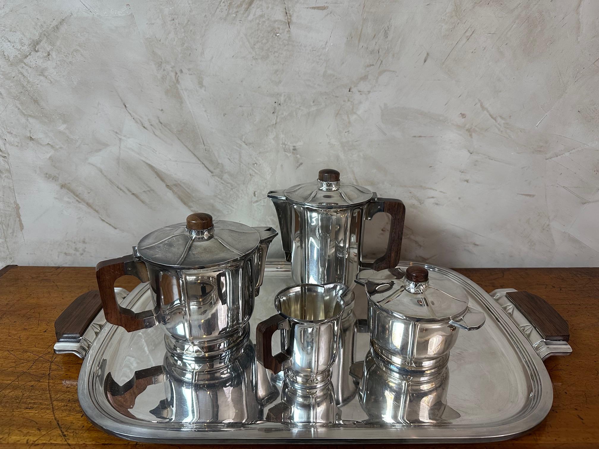 Very nice tea and coffee silver plate service from the French ERCUIS house from the art deco period composed of five pieces: teapot tray, coffee pot, sugar bowl and creamer. the handles are made of wood. 
Signed 
