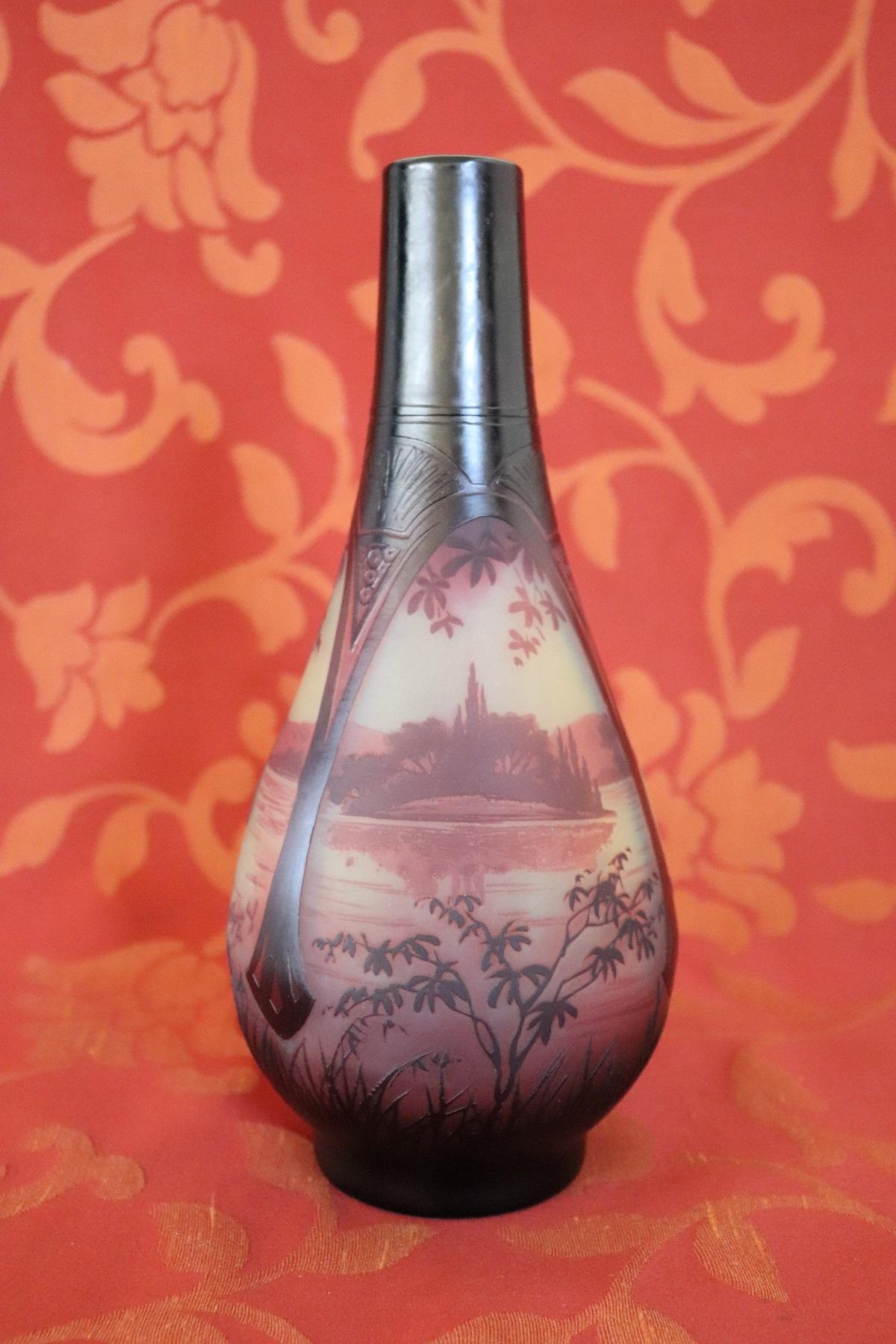 Important and refined French Art Nouveau vase in cameo glass with landscape decoration with lake finely etched to acid in purple-brown tones. Signature in relief cameo D 'Argental, followed by the initials S L (Saint Louis).
Paul Nicolas, born in