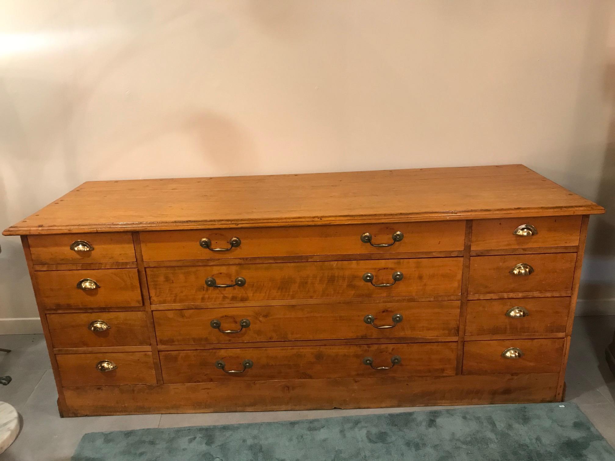 Beautiful 20th century French beech chests of drawer from the 1920s.
Gilded brass handles. Four large drawers in the middle and eight smaller drawer at the extremities. Very nice quality. This kind of furniture use to be in shop to exposed
