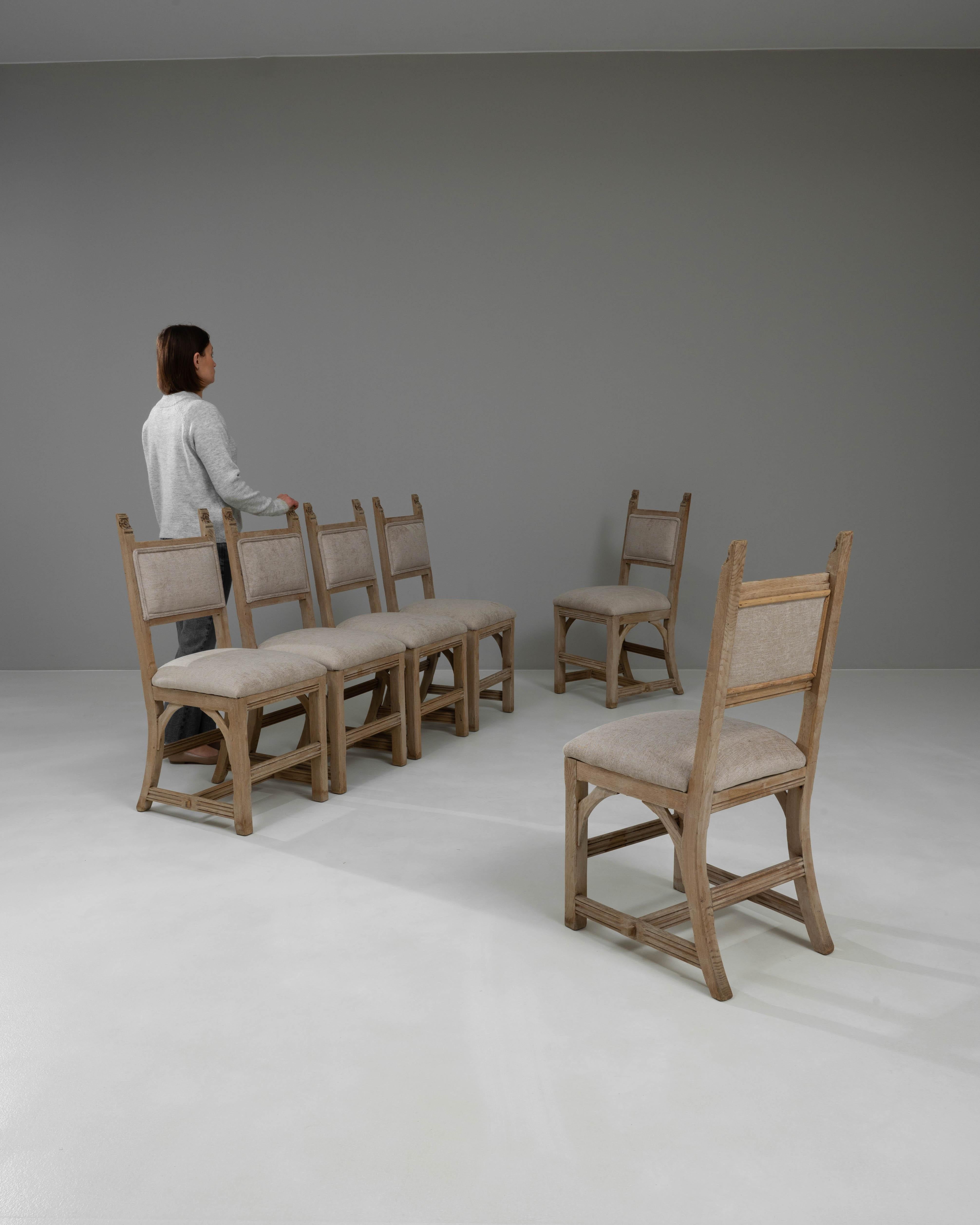 Step into the world of rustic elegance with this stunning set of six 20th Century French Bleached Oak Dining Chairs, designed to infuse your dining space with a sense of provincial charm. Each chair has been lovingly crafted from solid bleached oak,