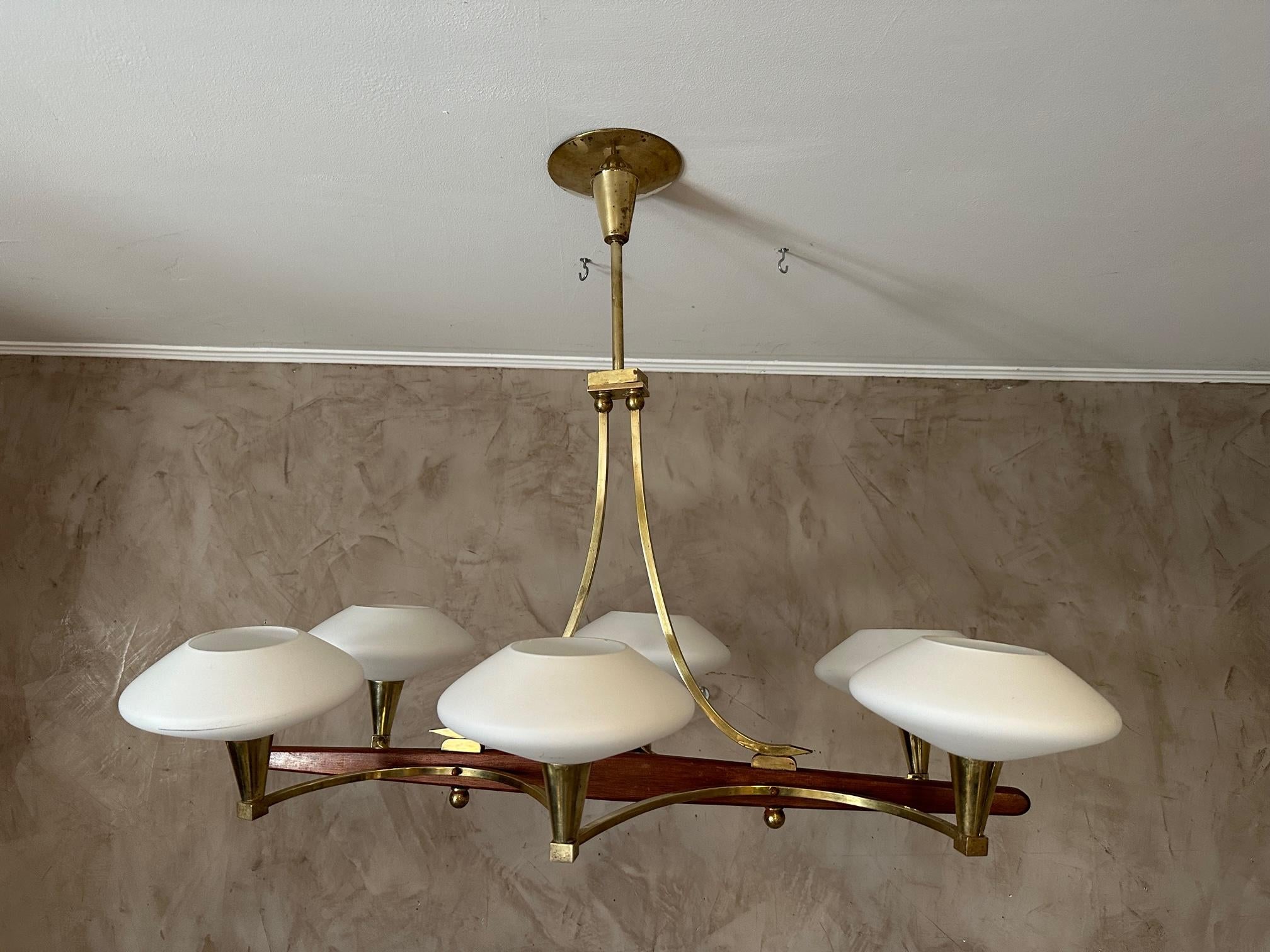Very beautiful vintage chandelier from the 60s in brass, wood and six lights in opaline glass. 
Very good condition. Beautiful brass structure. Beautiful quality and very elegant.
