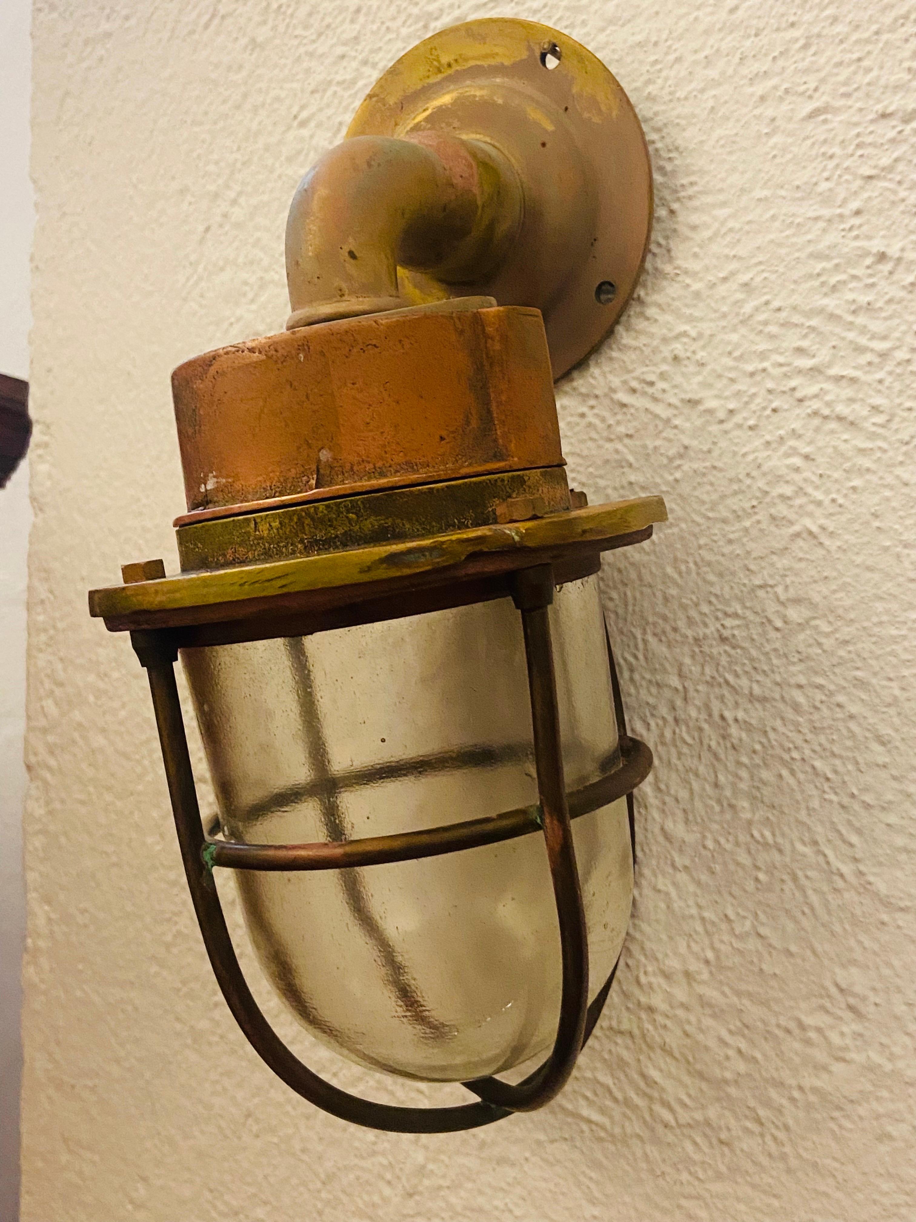 French small wall light made of brass and copper used in military vessels mainly marine minesweeper ships.
Circa 1930.