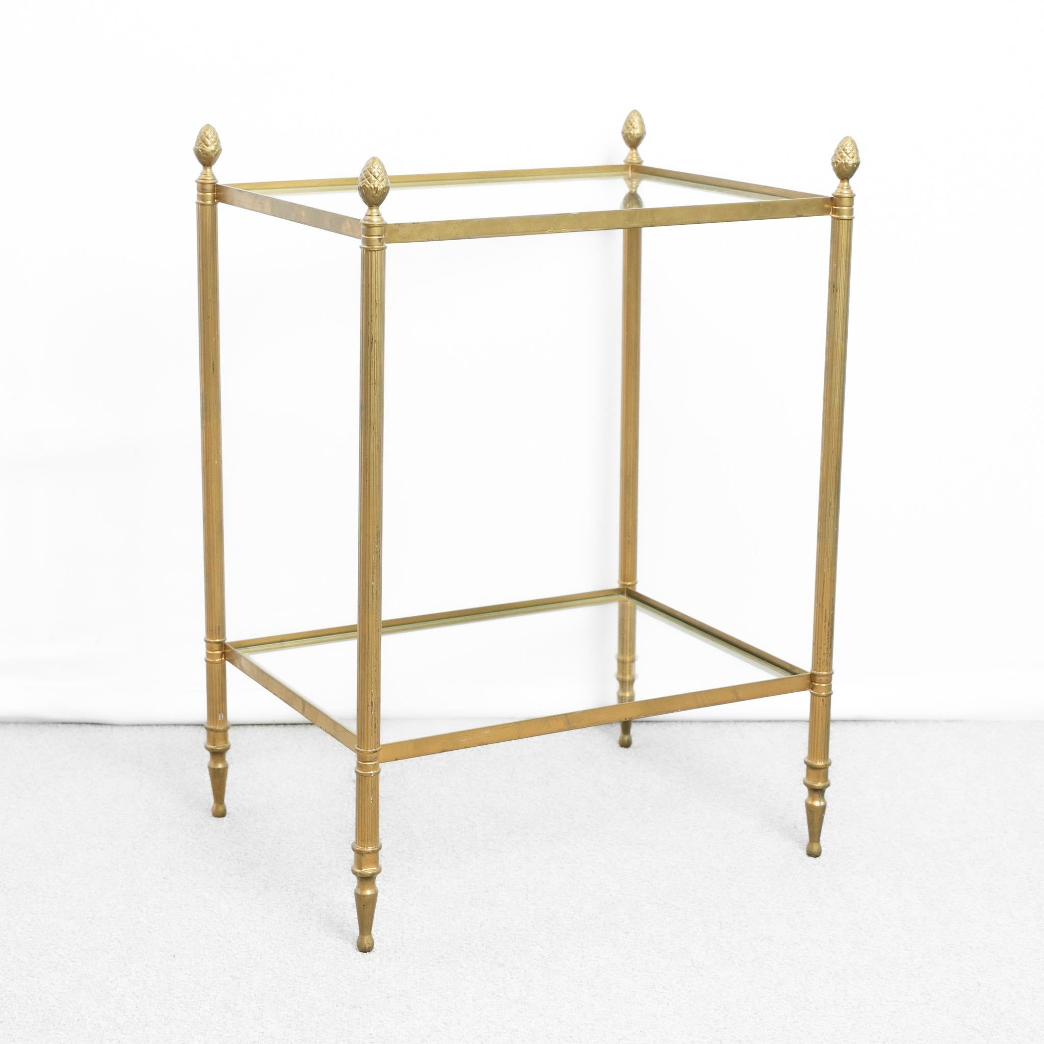 Table d'appoint en laiton et verre.
Avec deux étagères en verre transparent et des embouts en forme de gland.

France, vers 1950.

Hauteur - 61cm
Largeur - 44cm
Profondeur : 34 cm
Veuillez envoyer un message si vous avez besoin de plus