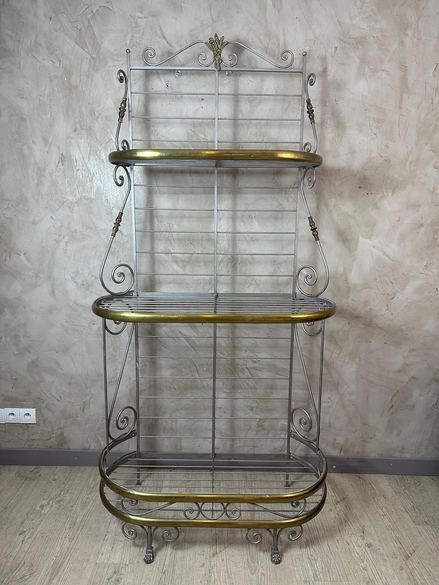 Beautiful French vintage bakery shelf in metal, dating from the 1950s, in good condition.
It features an elegant wrought iron structure, enhanced with decorative details and lovely gilt brass finishes that give it great charm.

Perfect for shop