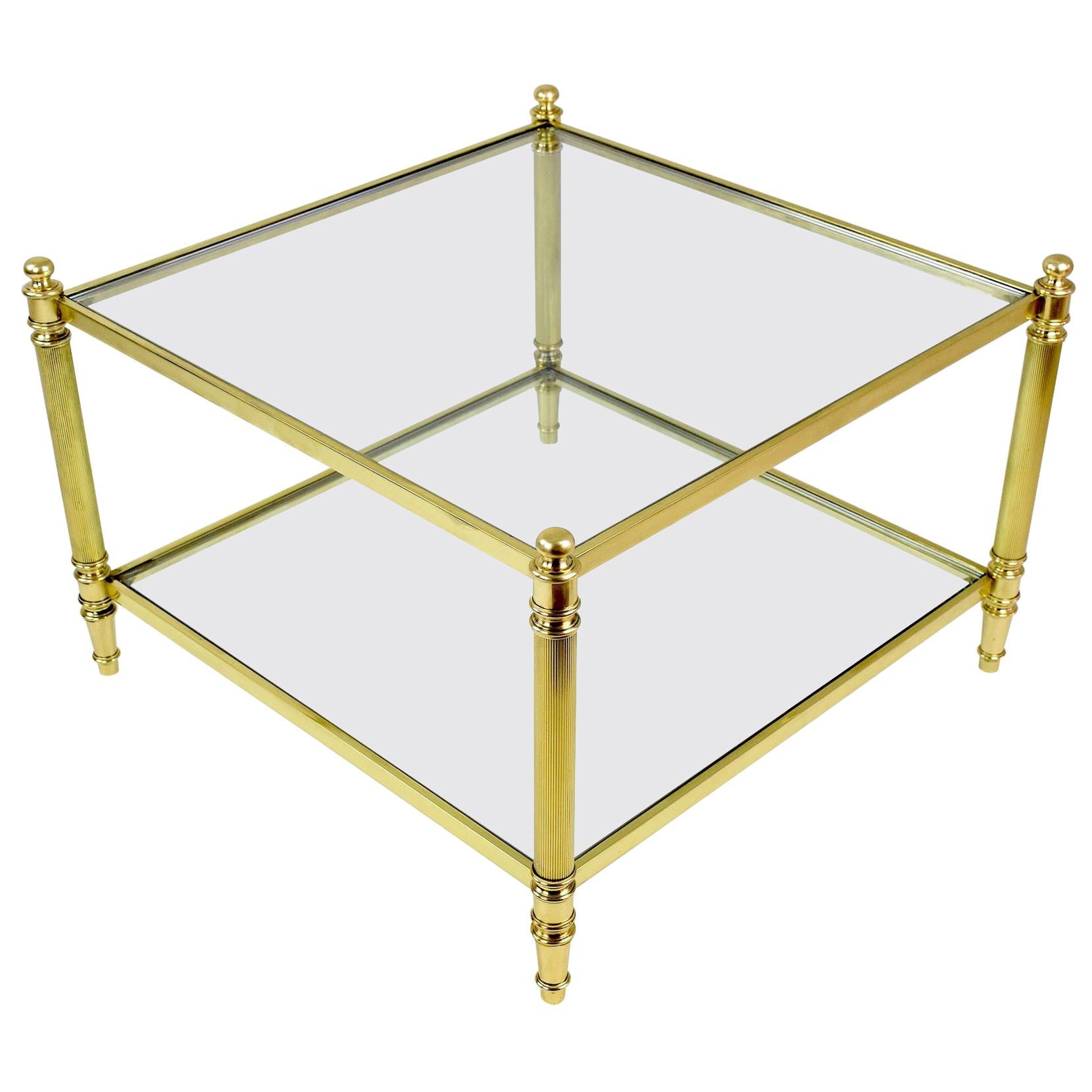 20th century vintage two-tiered square coffee or side table in solid gold brass structure and clear glass in Hollywood Regency style.
In beautiful condition with all original glass.
France, circa 1960s-1970s, in the style of Maison Jansen.
 ----
All