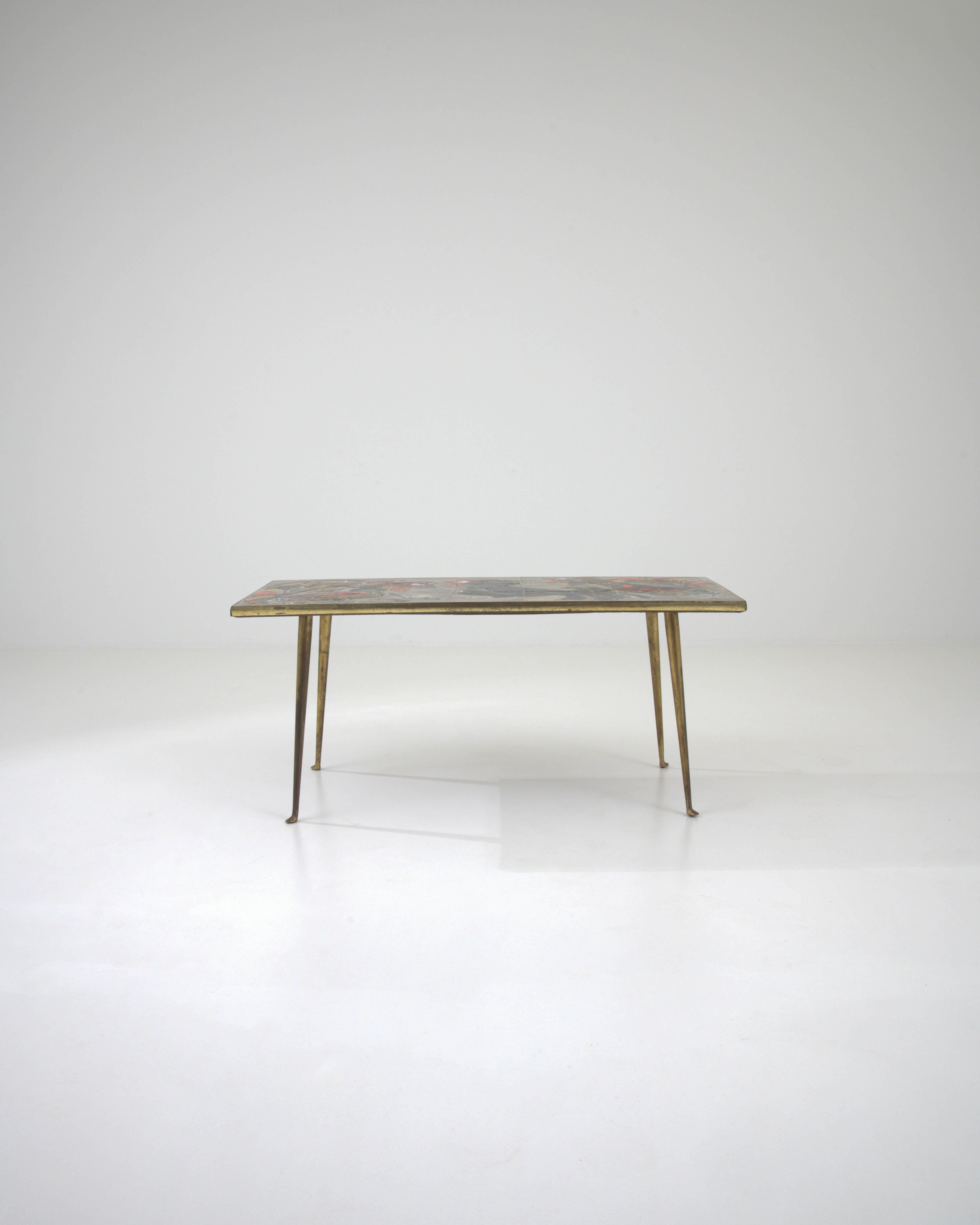 Elevate your living space with the allure of this 20th Century French Brass Coffee Table, featuring a ceramic top that is as much a piece of art as it is a functional furnishing. The sleek, minimalist brass legs, with their subtle curve and golden