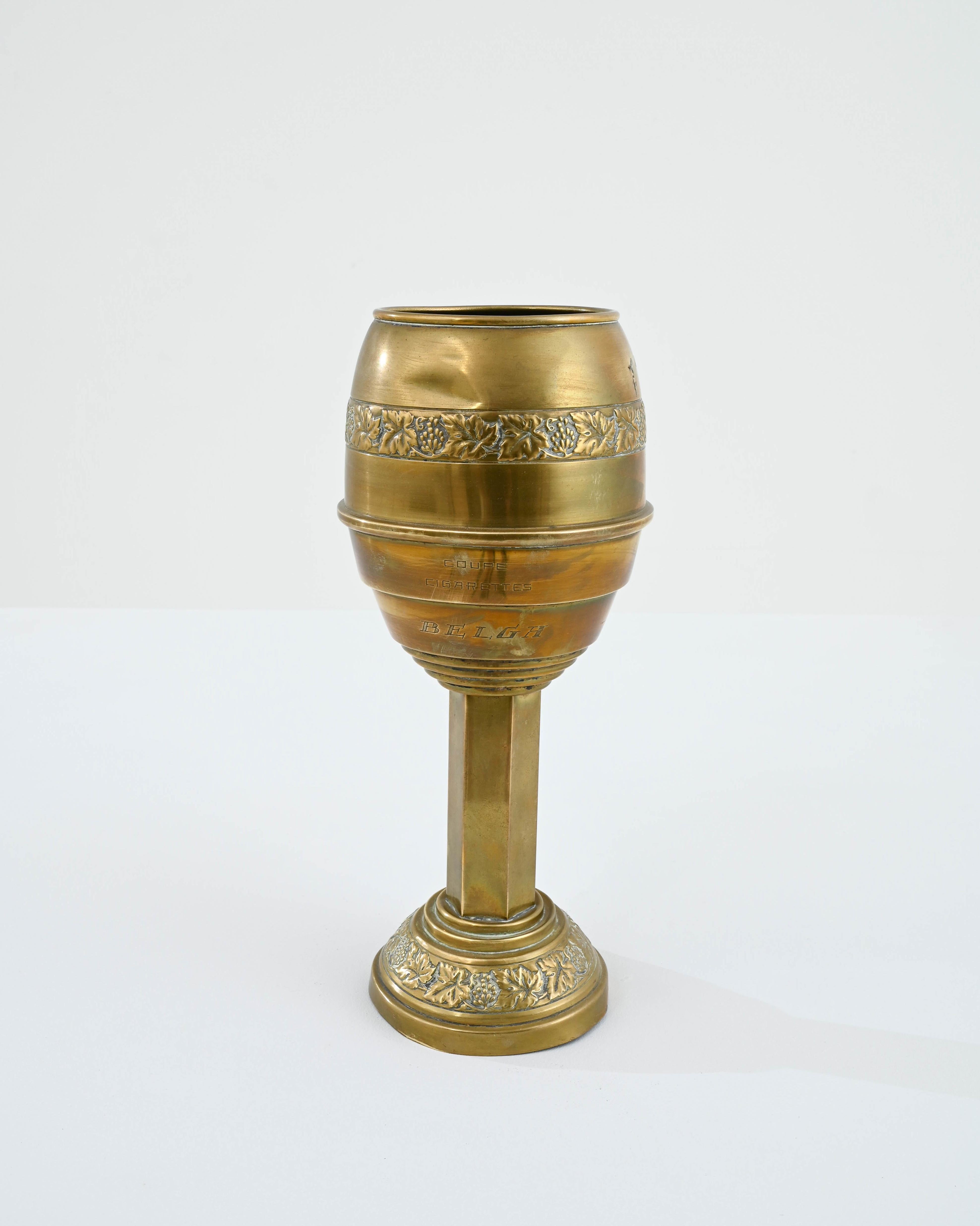 With its ornate metalwork and beautiful golden gleam, this vintage brass goblet has the air of an object from a fairytale. Made in France in the 20th century, intricate patterns of embossed grapes and vine leaves decorate the swell of the cup and