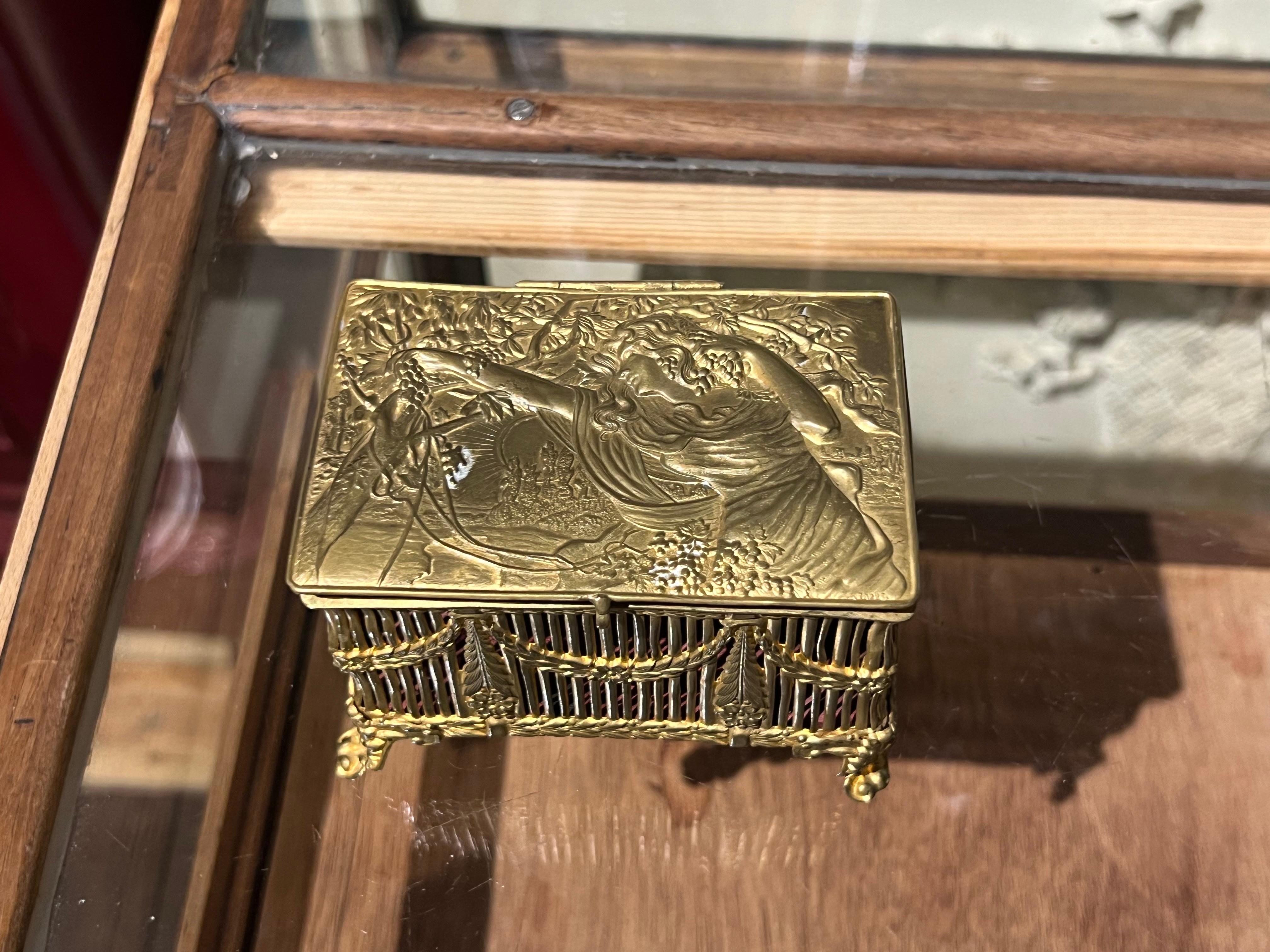 French hand made brass jewellery box made 100 years ago with extremely beautiful details and fine decoration especially on the top where a young woman with long hear is carved surrounded with grapes and flowers. The condition is really good and no